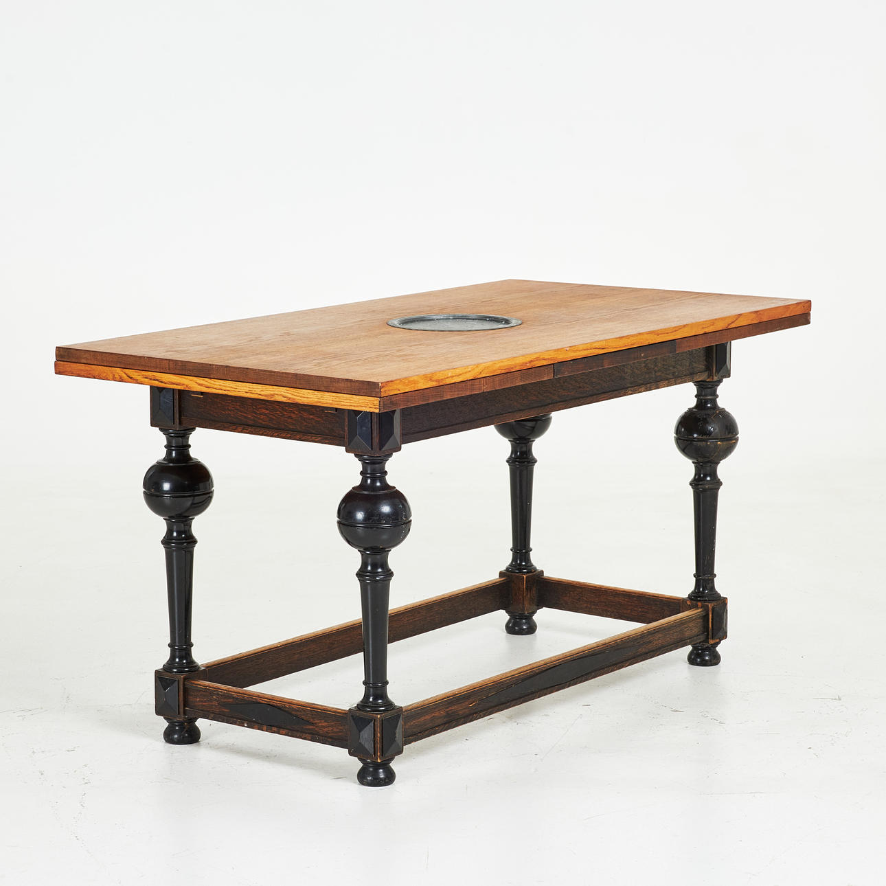 DINING TABLE, 20th century, Baroque style, recessed tin dish in the middle, solid oak, dark stained legs, extendable.