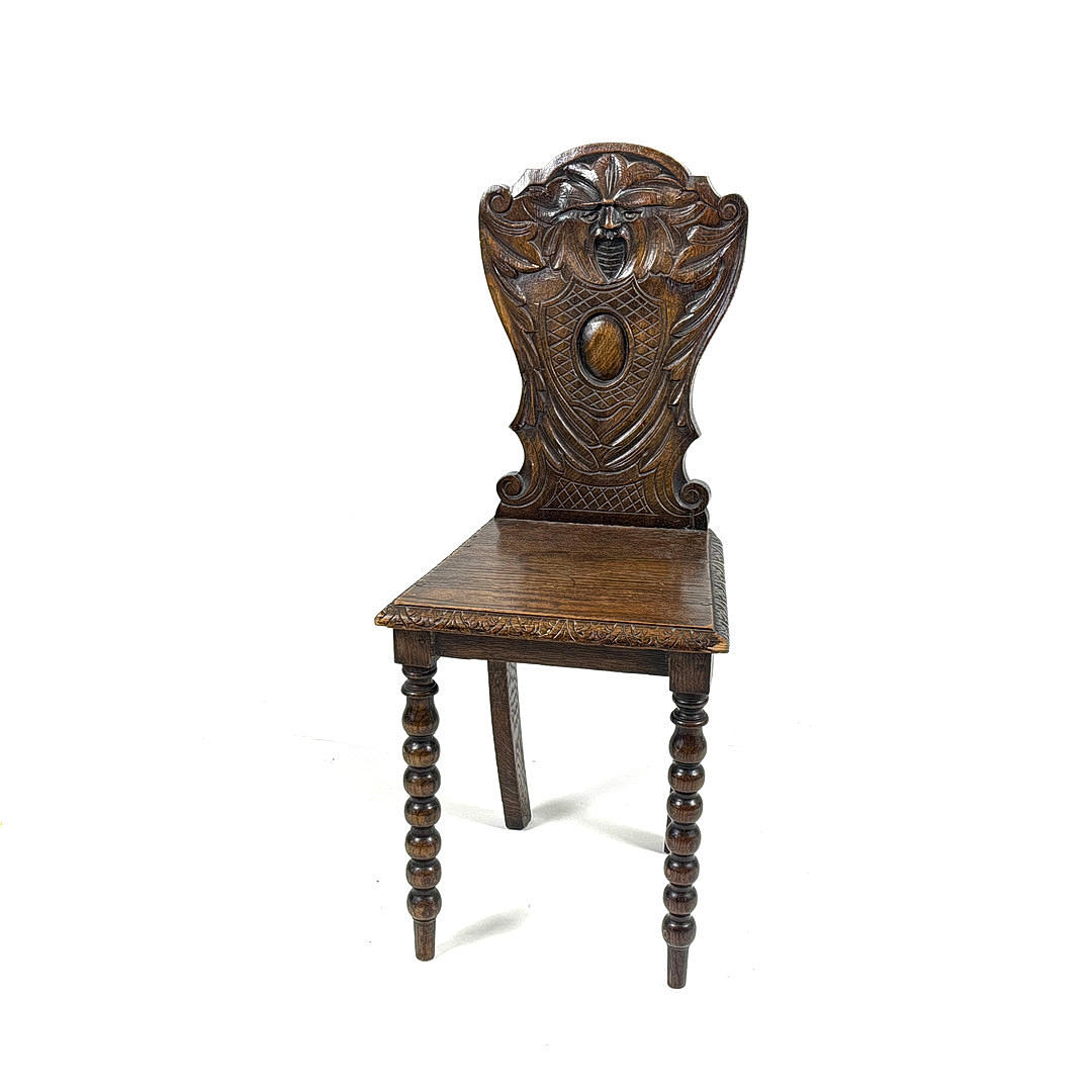 ANTIQUE CARVED OAK HALL CHAIR.