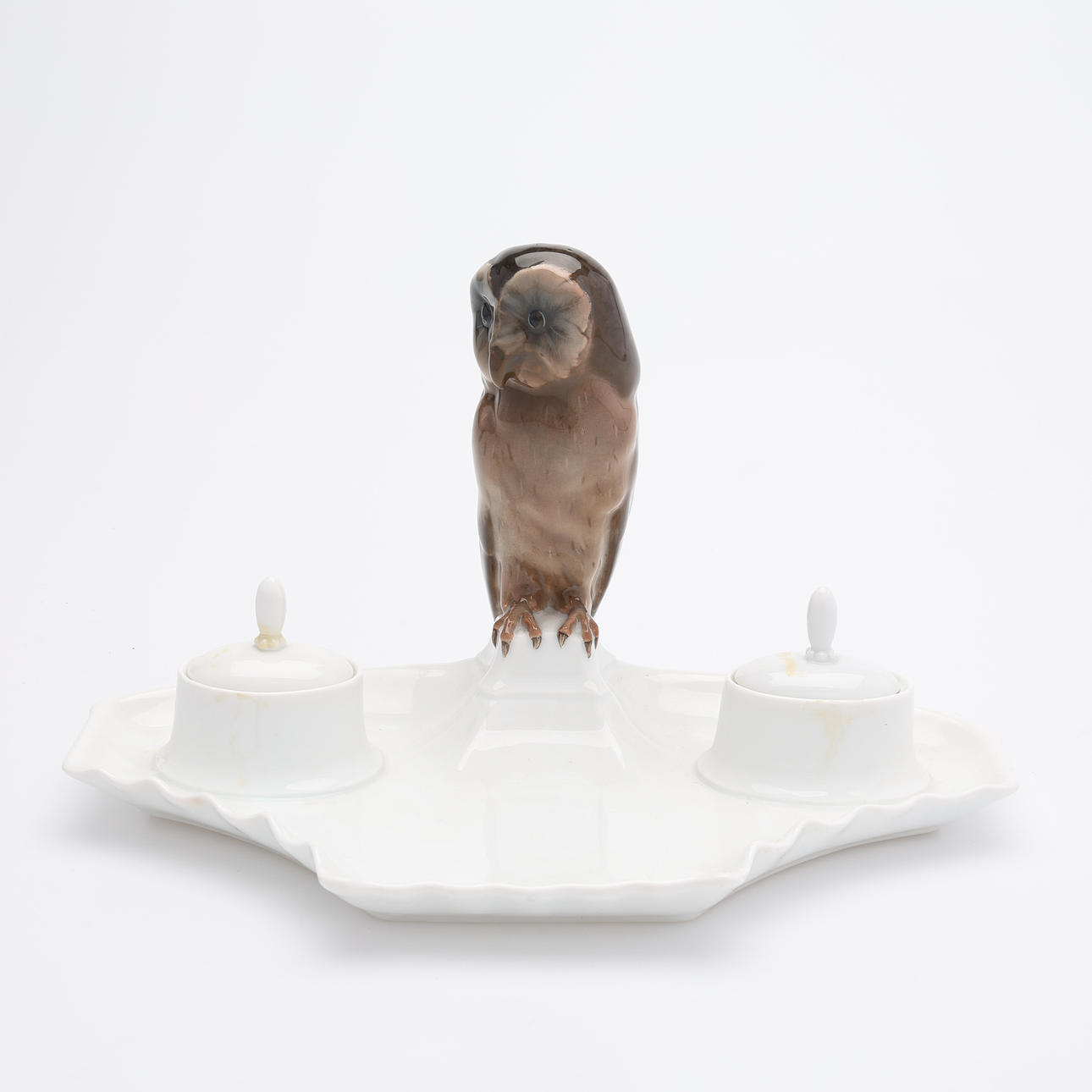 A ROSENTHAL DESK SET, designed by Wilhelm Veit in 1912, porcelain with a crowned owl, first half of the 20th century.