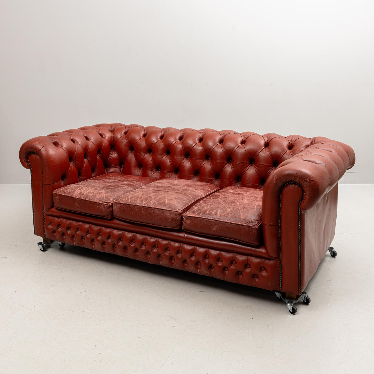 A red leather sofa, Chesterfield model, Arne Norell, designed 1960s.