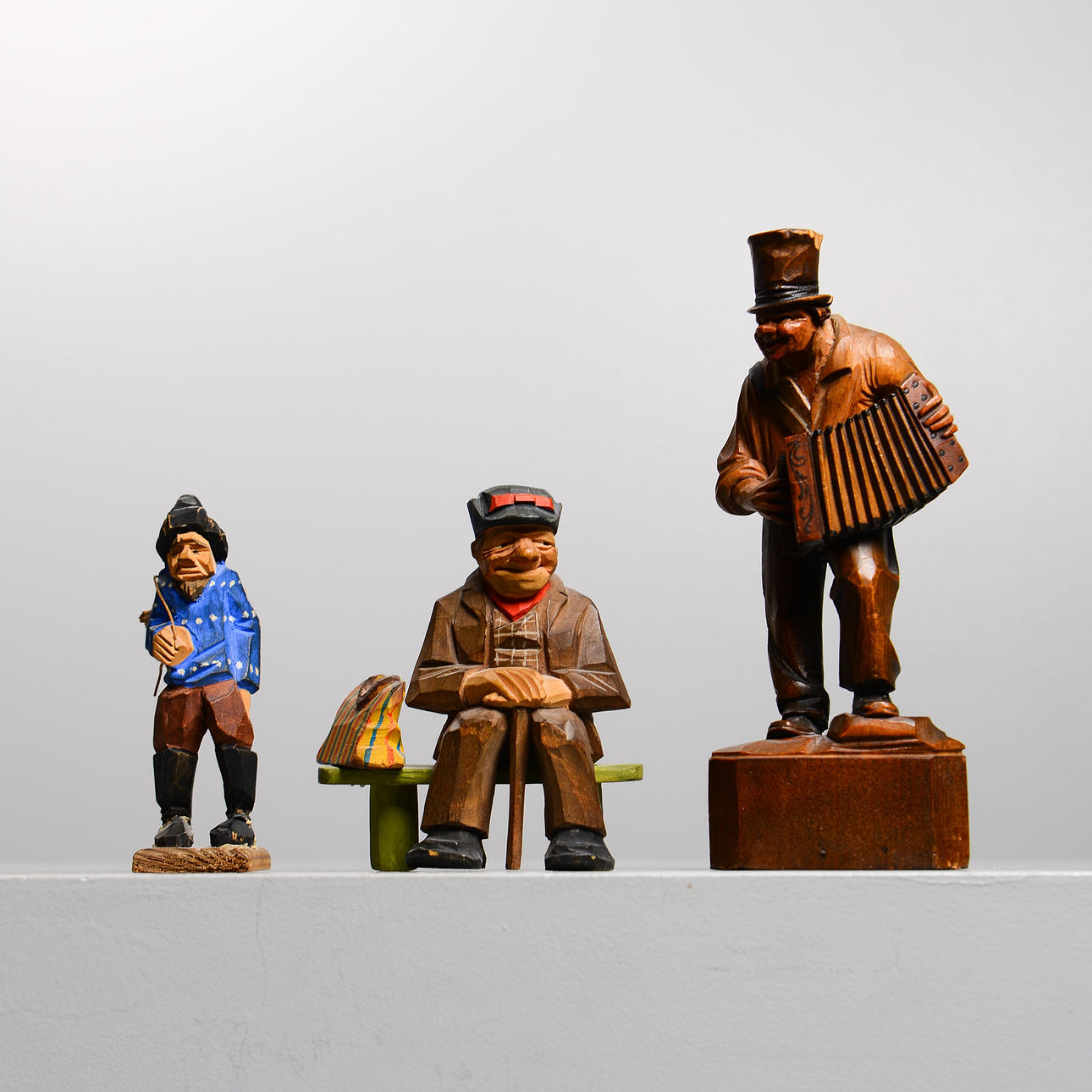 WOODEN FIGURES, 3 pieces, partially signed.