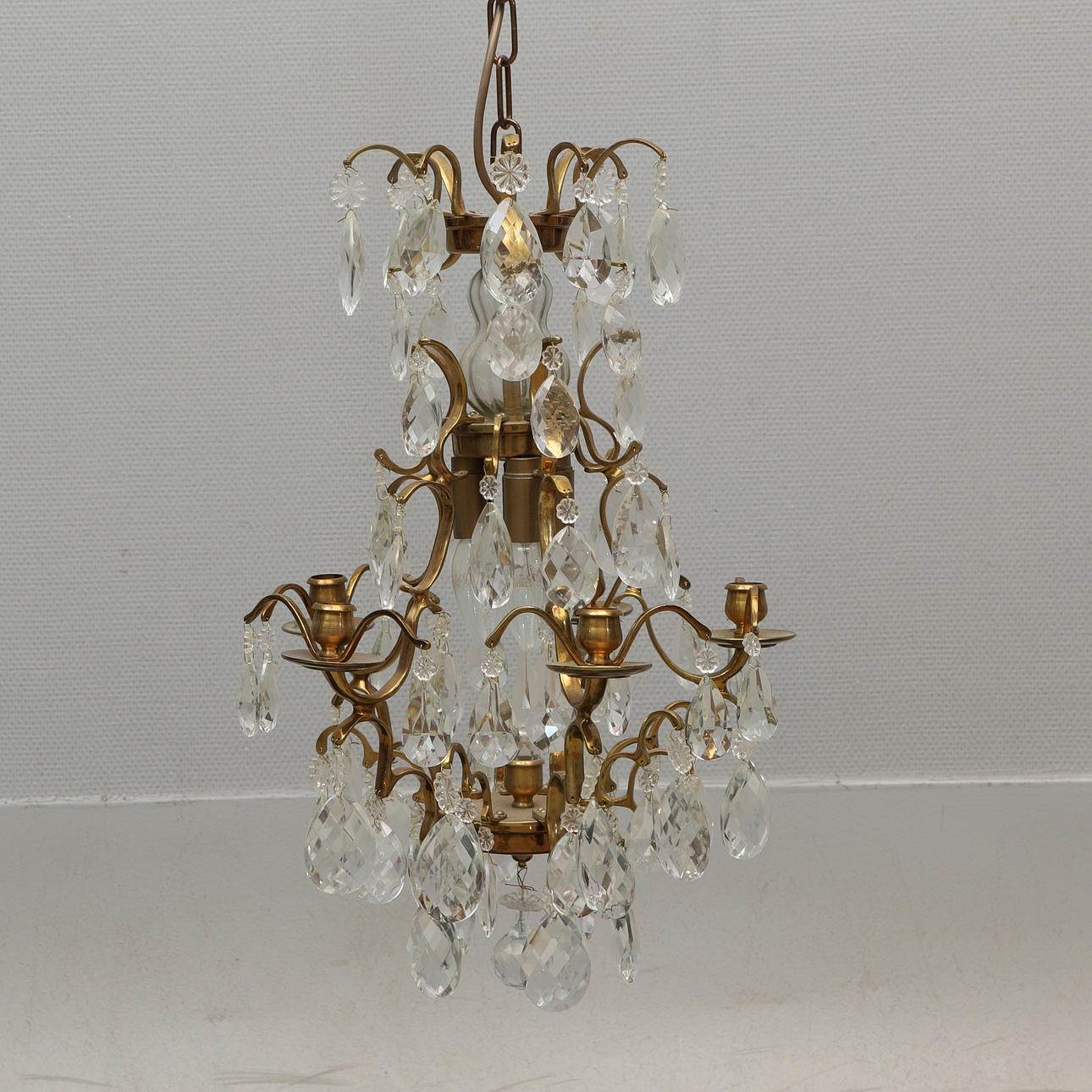 CRYSTAL CHANDELIER, Rococo style, with light arms, brass & prisms.