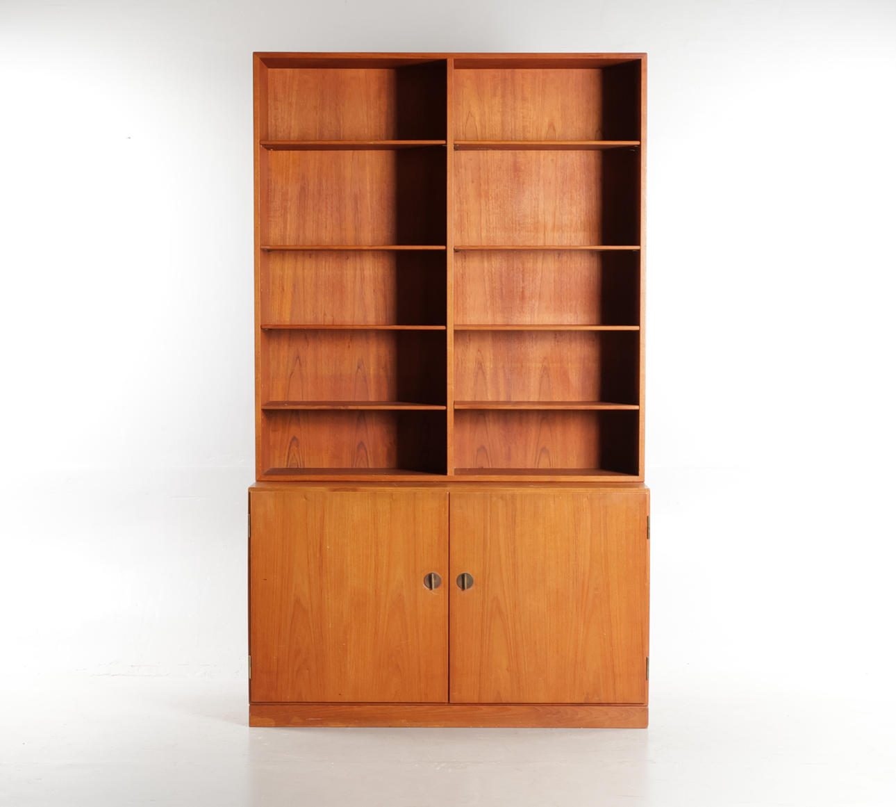 BØRGE MOGENSEN. Sideboard made of teak, front with two doors with keys/handles made of brass above upper with removable shelves. Done and branded at C.M. Madsen for FDB. (2nd).