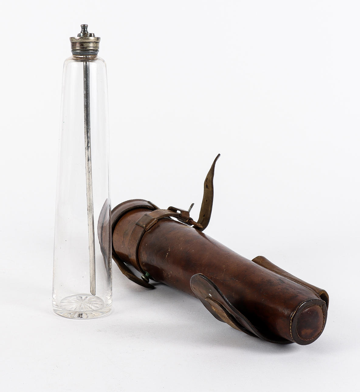 GLASS BOTTLE in leather case.