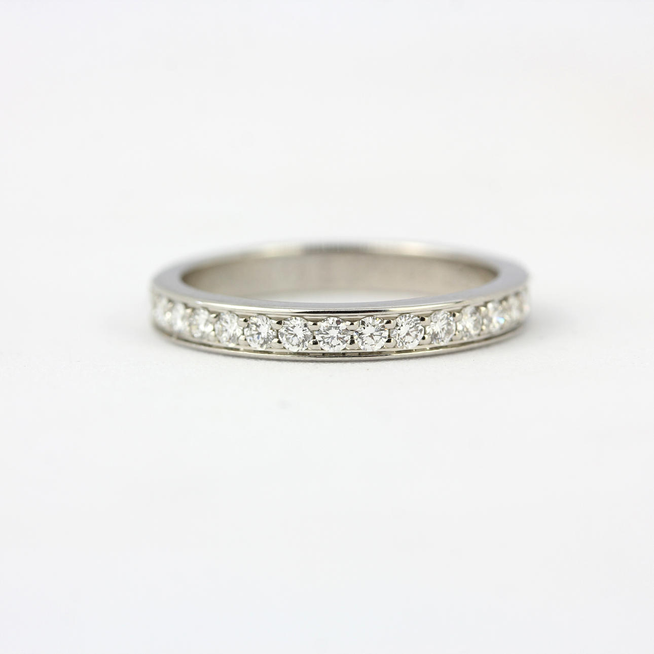 18CT WHITE GOLD CARTIER HALF ETERNITY RING.