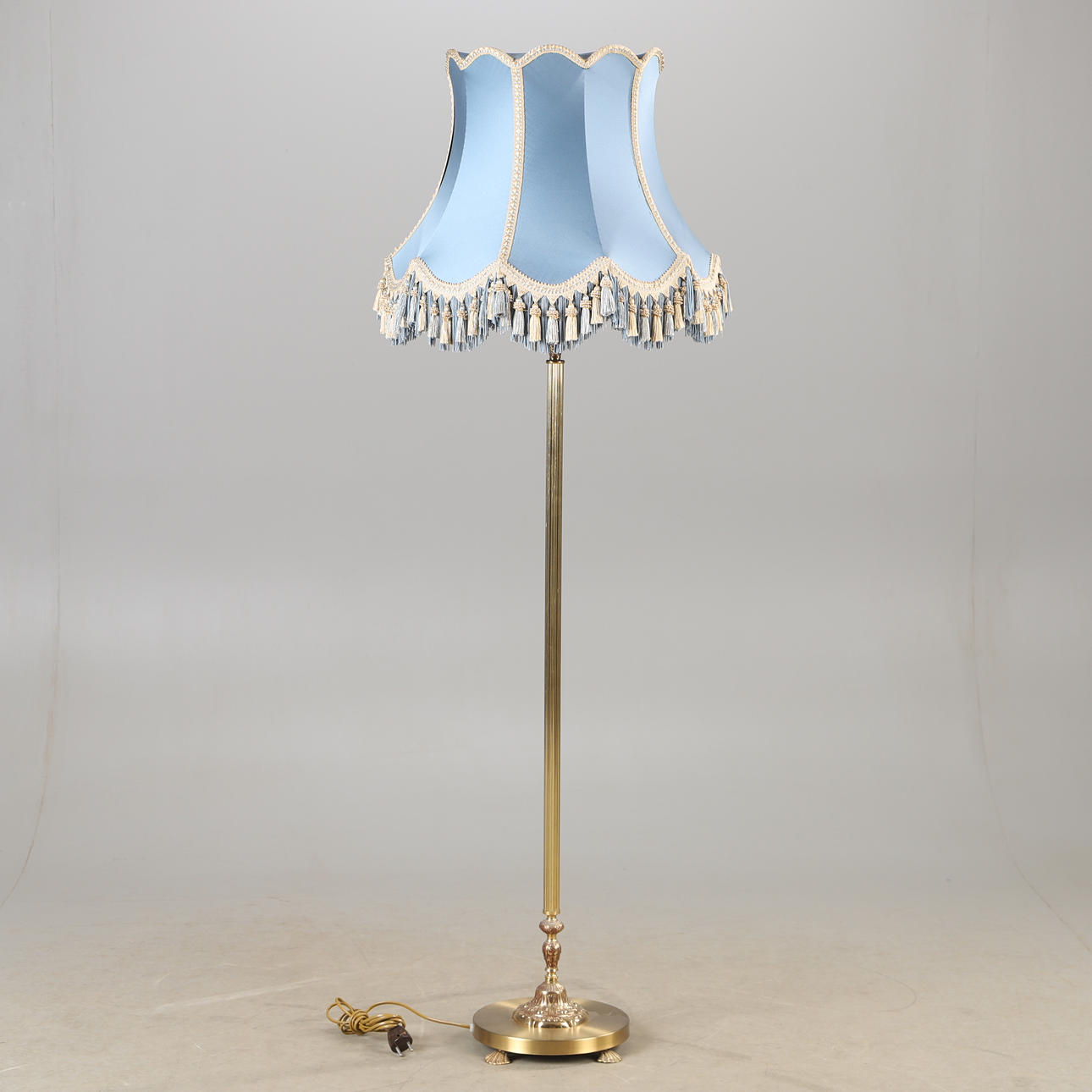 A brass floor lamp, mid 20th century.