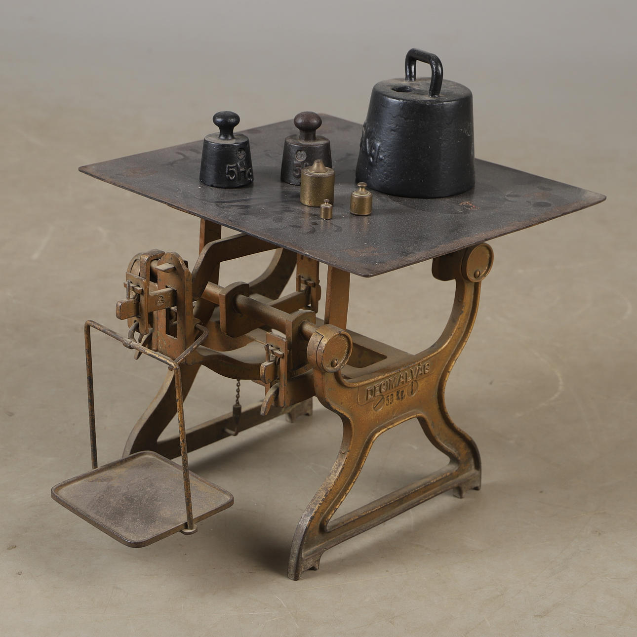 A metal decimal scale with weights, 20th century.