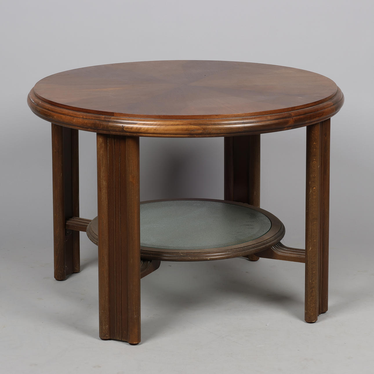 Circular coffee table with stained beech frame, mahogany veneer top and underlying glass shelf, art deco, European furniture maker, first half of the 20th century.