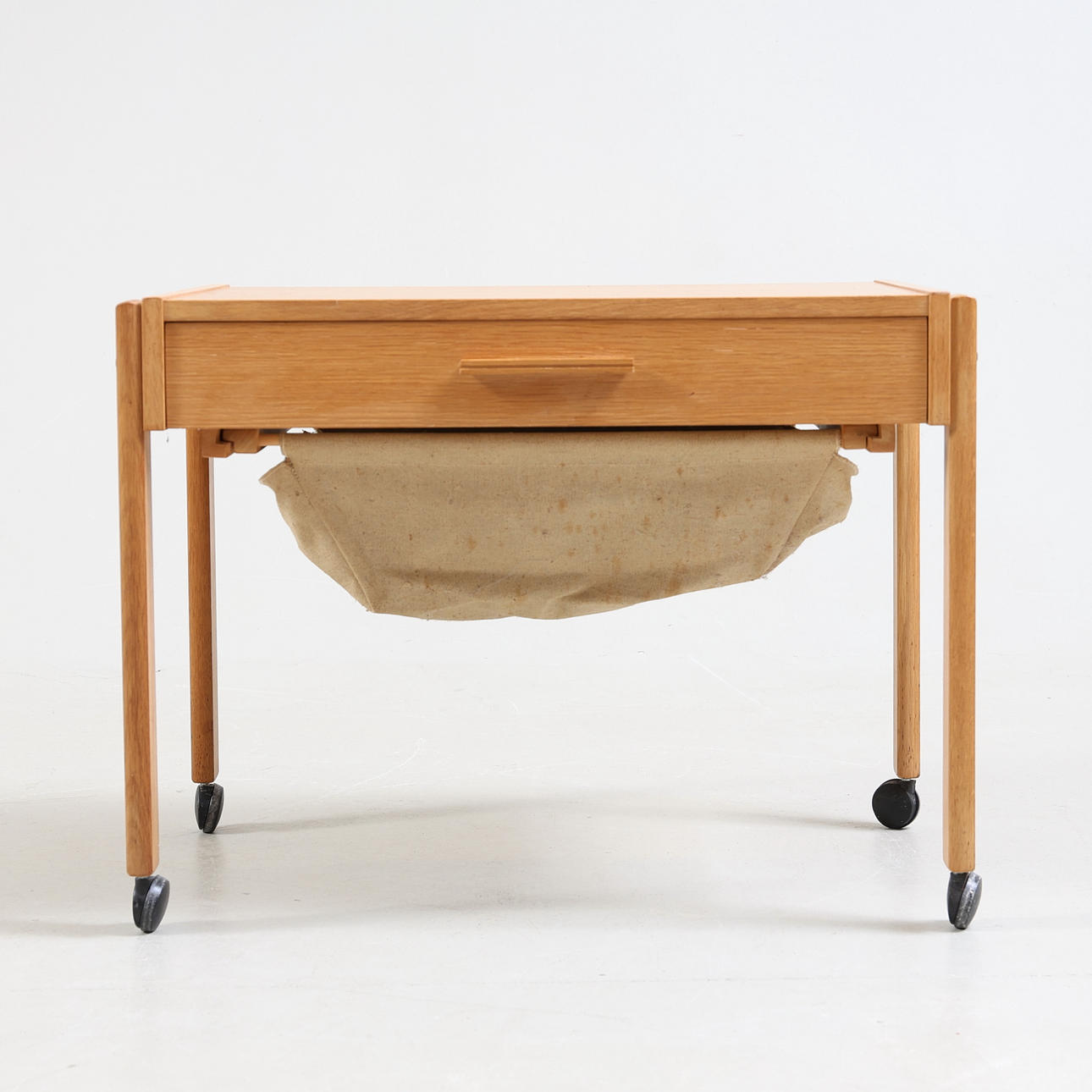 A 20th century oak & canvas sewing table.