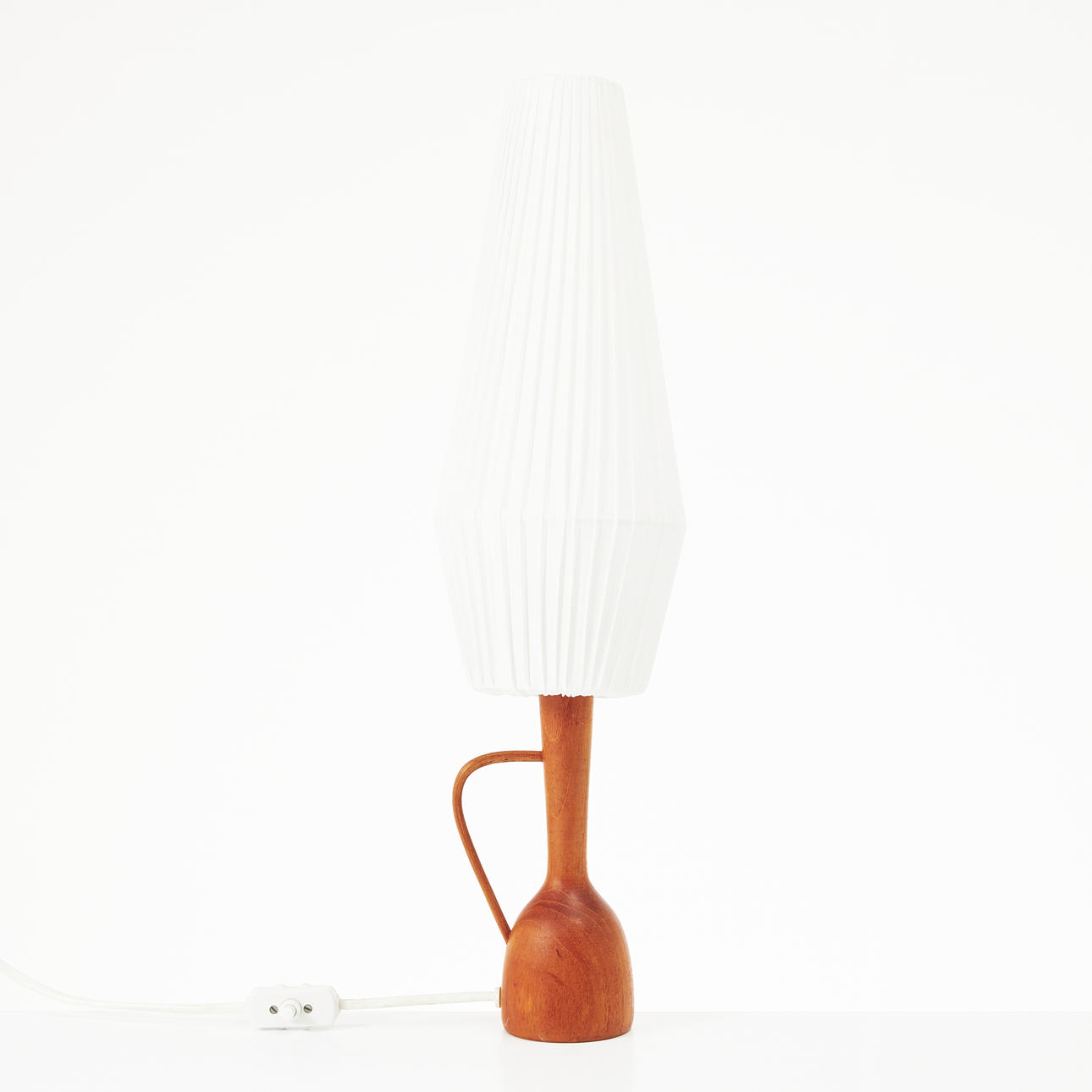 A 1960's table lamp, teak base, light lampshade.