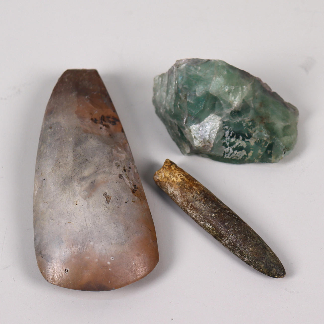 Stone/flint axe, green Fluorite and “Hydrogen candle”, (fossil after Belamite, extinct type of squid).