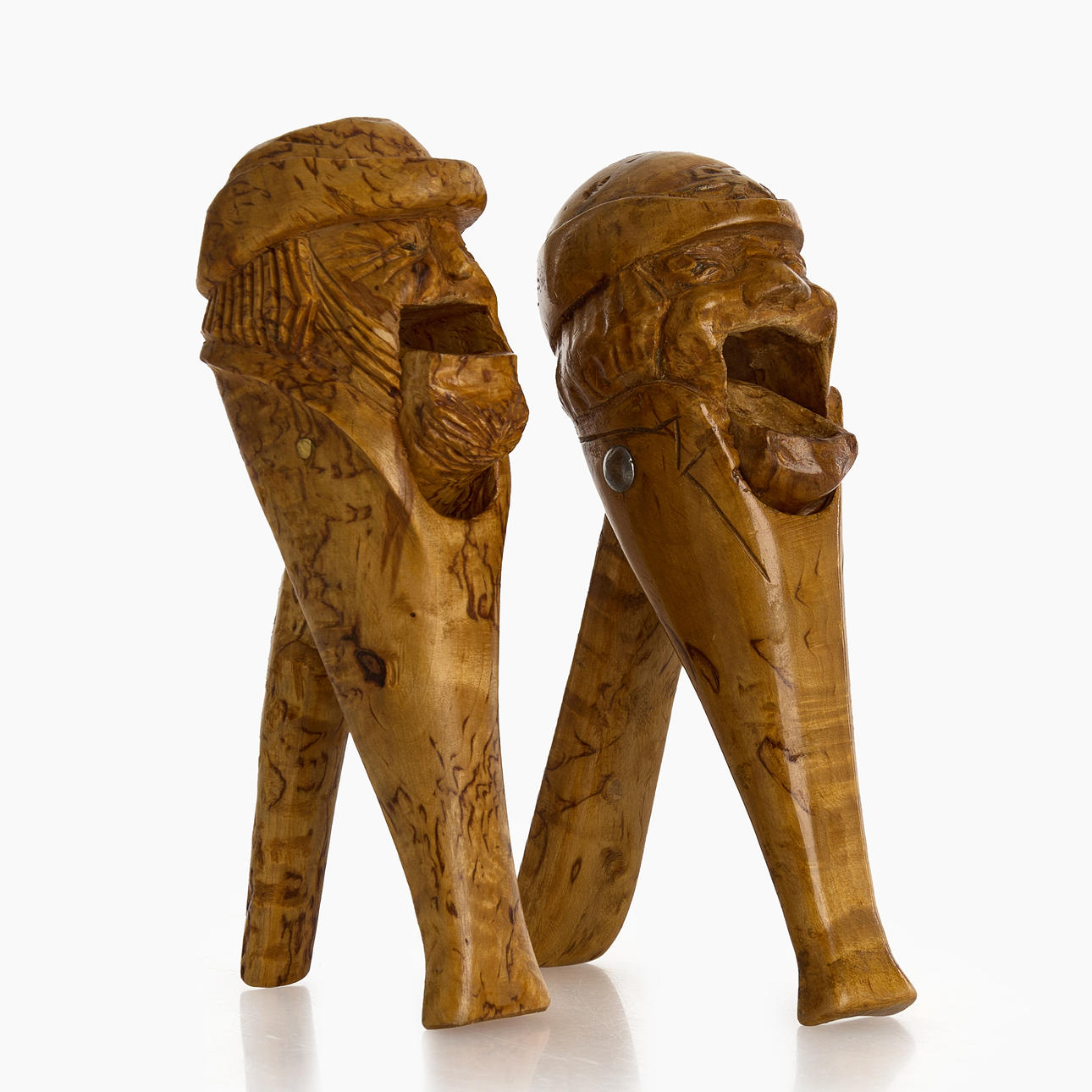 2 NUTCRACKERS, signed SB, one dated 1916, carved wooden root.