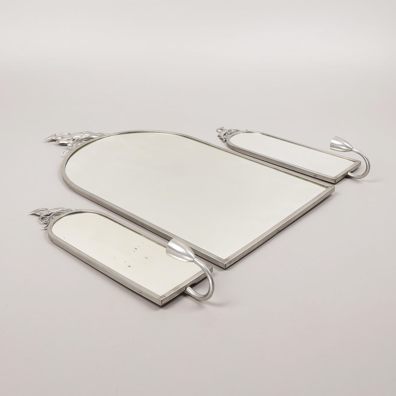 A 3-piece pewter mirror with candlesticks, 1930s.