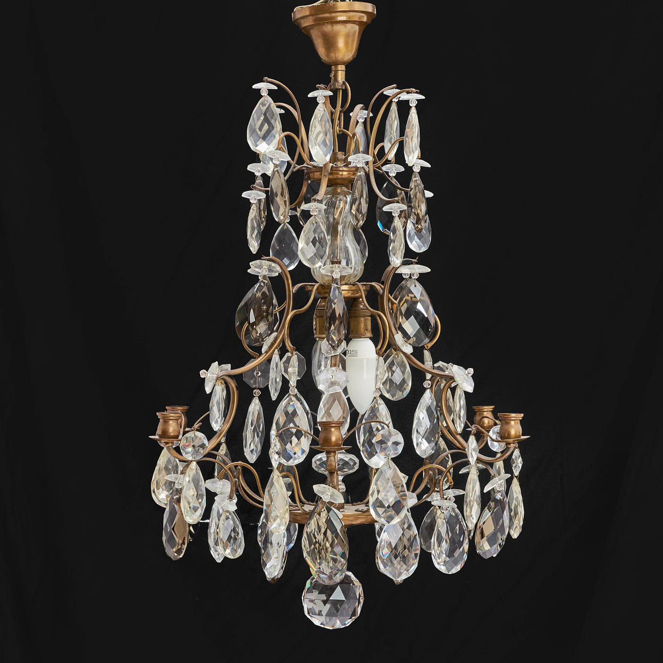 A rococo style chandelier, 6 light arms and 3 light points, clear and grey-toned prisms, 20th century.
