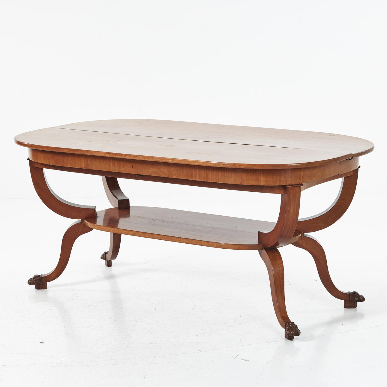 A table, first half of the 19th century, mahogany veneer, foot finish in the form of sculpted lion paws.