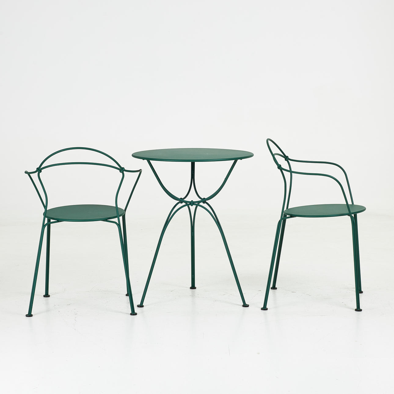FRÉDÉRIC SOFIA. TABLE and 2 ARMCHAIRS, “Airloop”, Fermob, green lacquered metal.