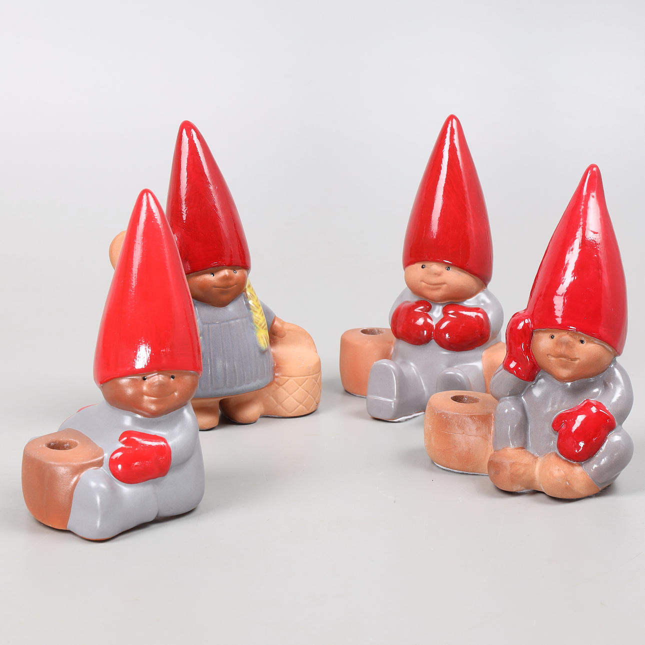 LISA LARSON. Candlesticks, 4 pcs, in the shape of gnomes, earthenware, from the series “Tomtefamilie”, Gustavsberg, label-marked.