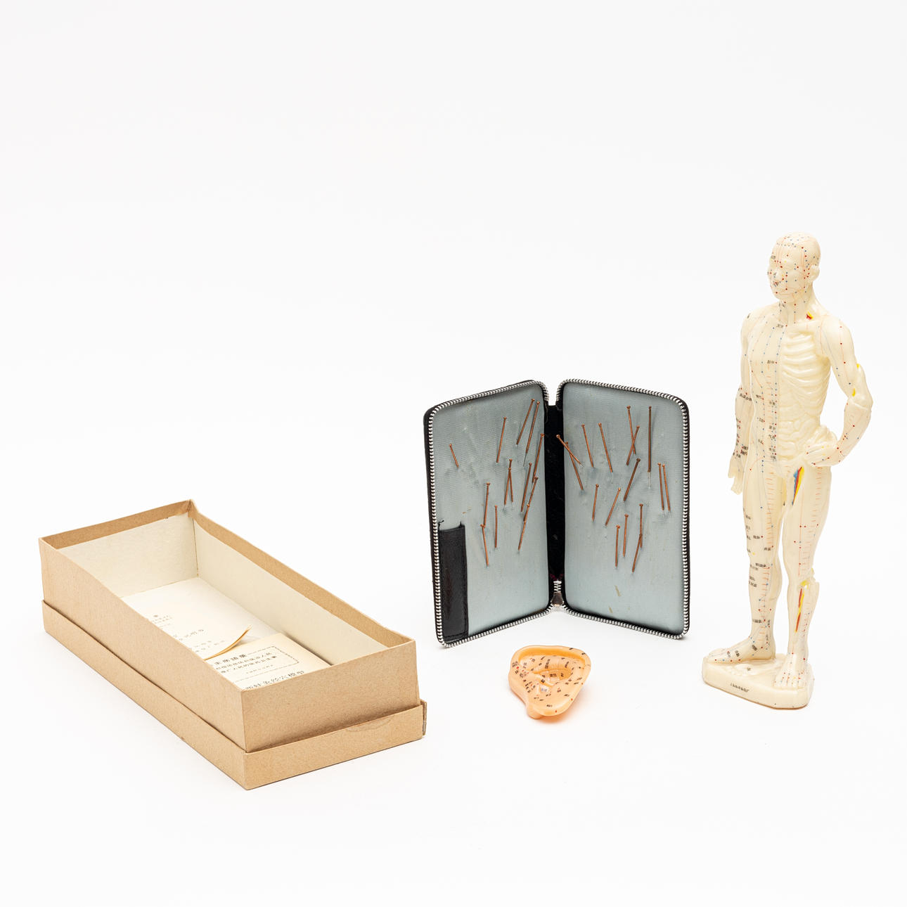 ACUPUNCTURE DOLL, with associated needles and instructions.