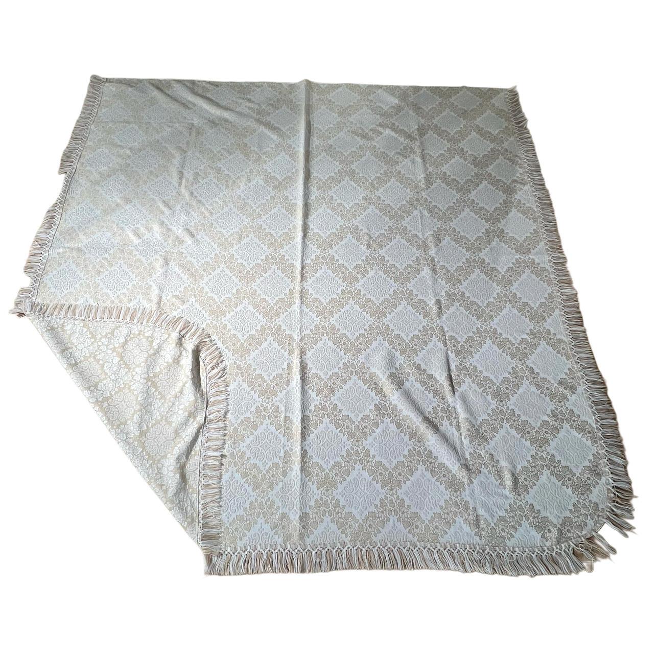 Damask bedspread in beige and brown tones.