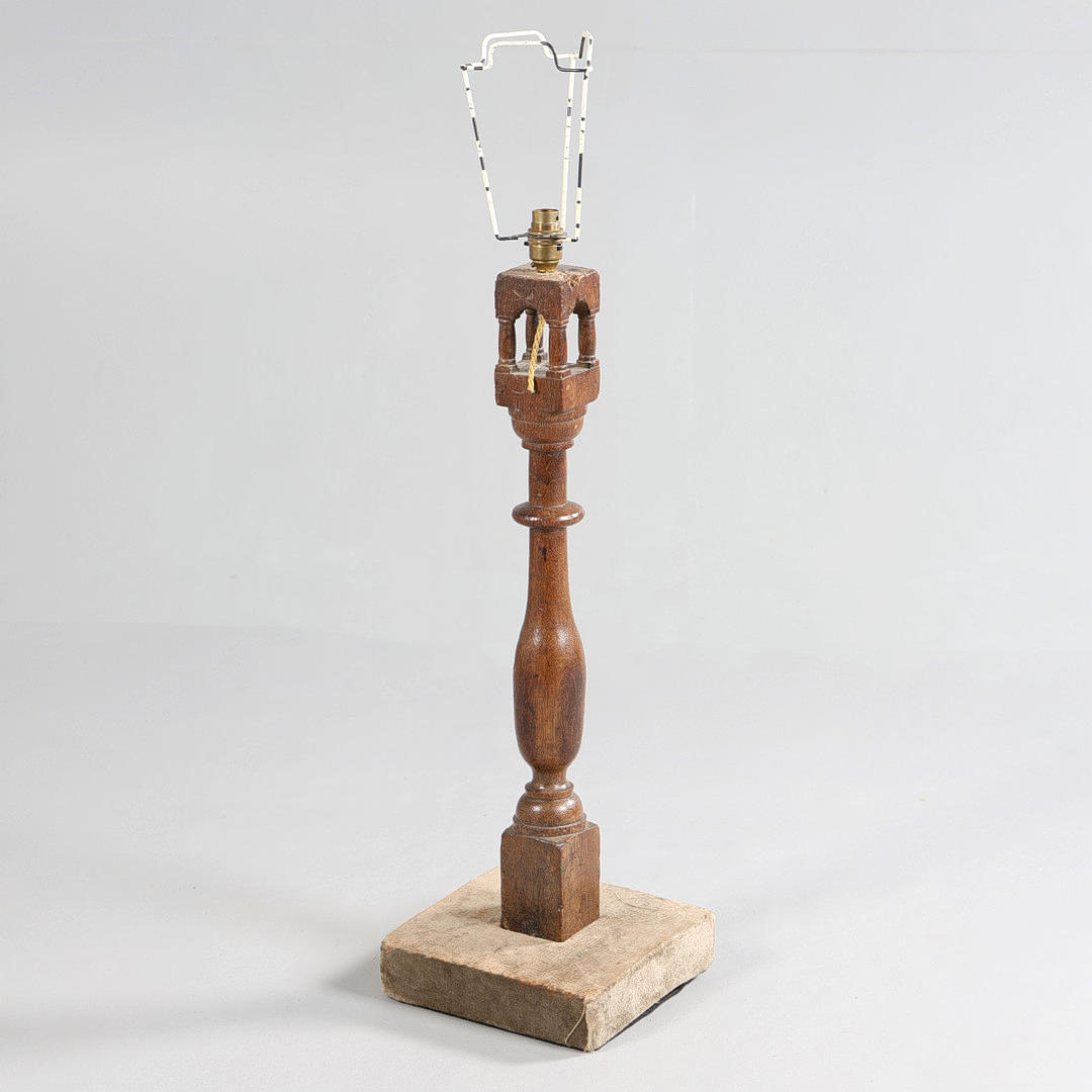 A GEORGE III AND LATER OAK CARVED COLUMN CONVERTED INTO A LAMP.