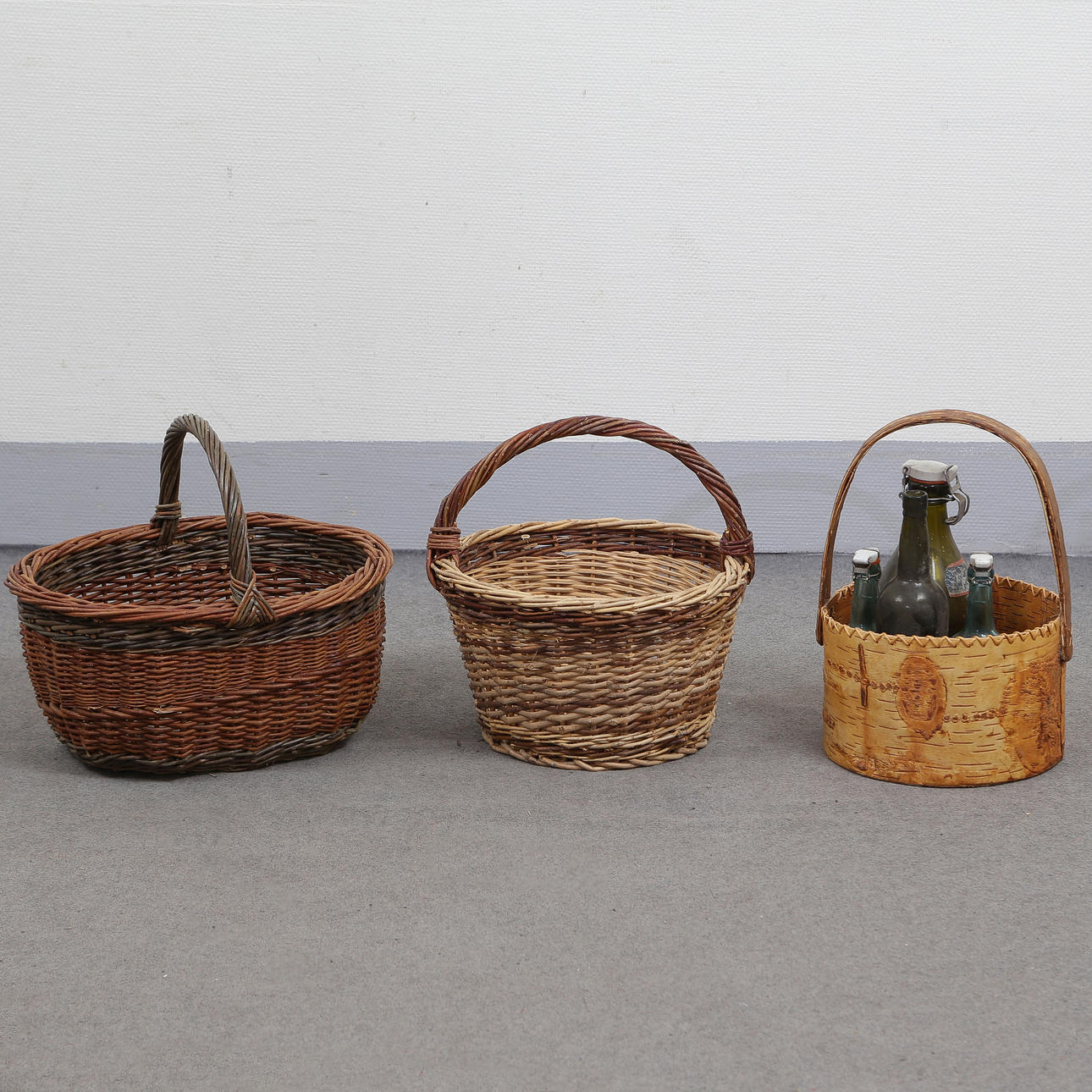 3 BASKETS AND 4 OLDER DRINKING BOTTLES.