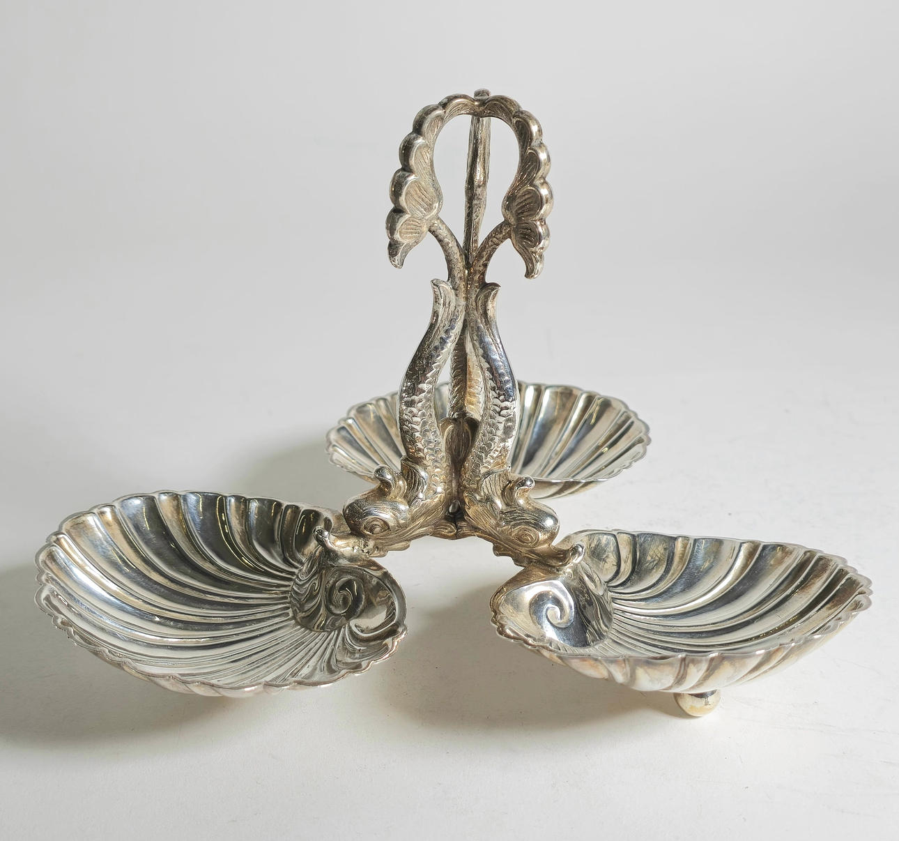SILVER SPICE RACK WITH SHELLS AND FISH.