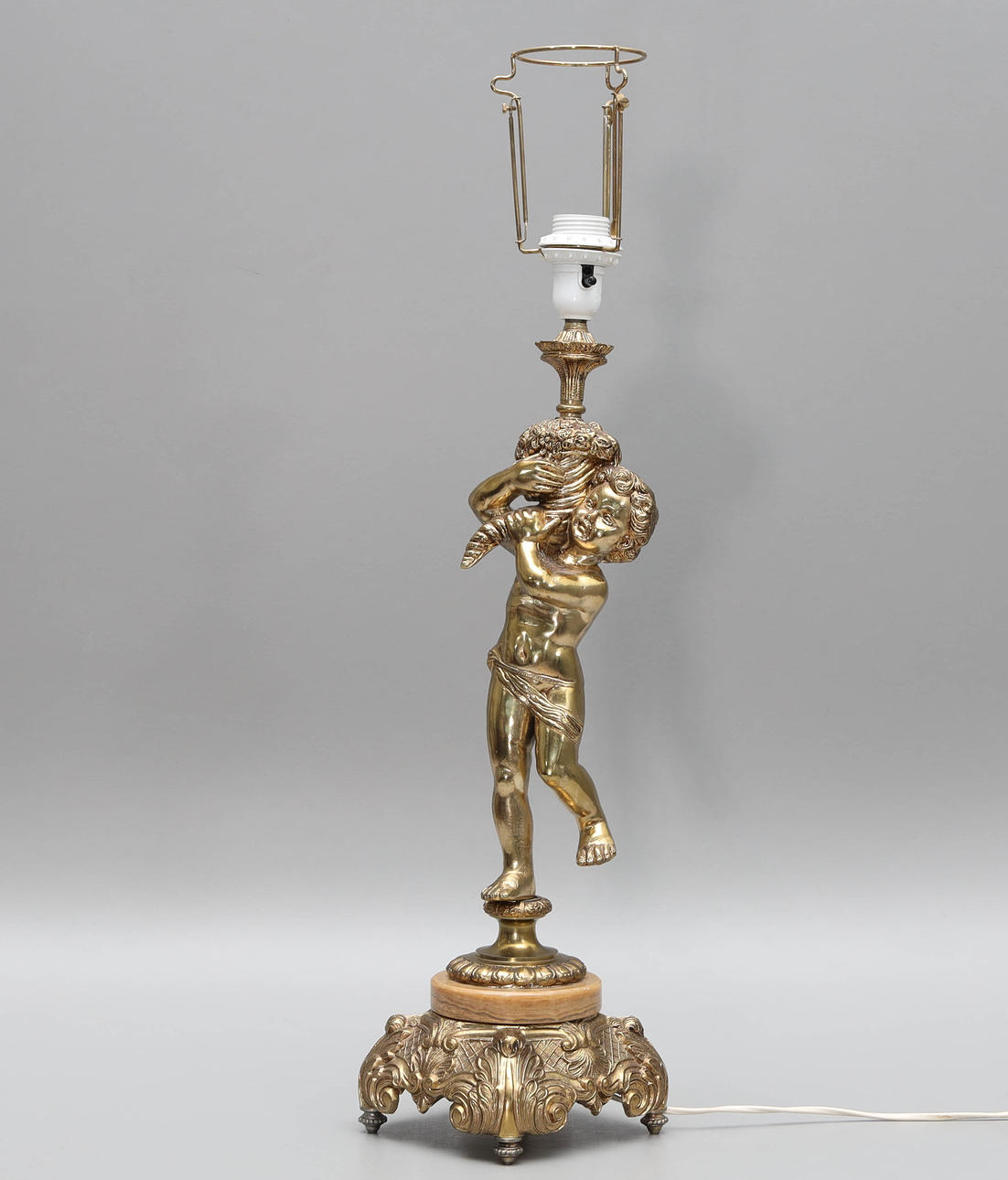 A 20th-century putti gilt table lamp.