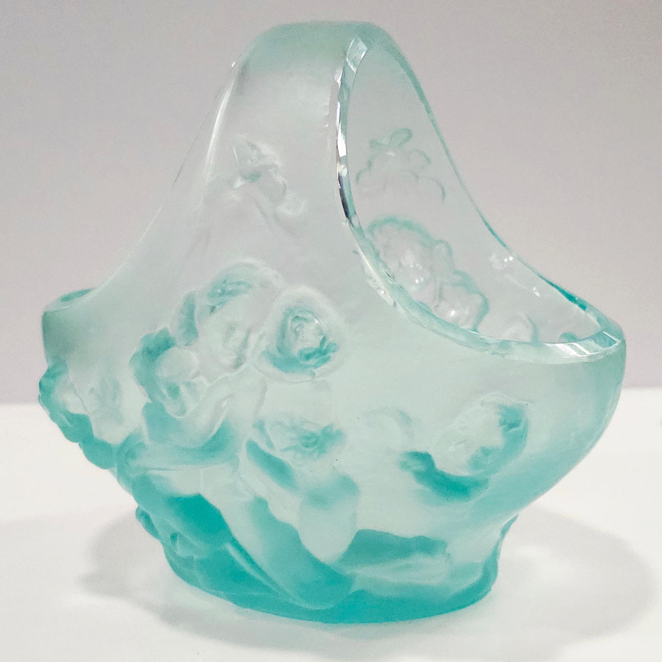 Blown glass basket with neoclassical scene.