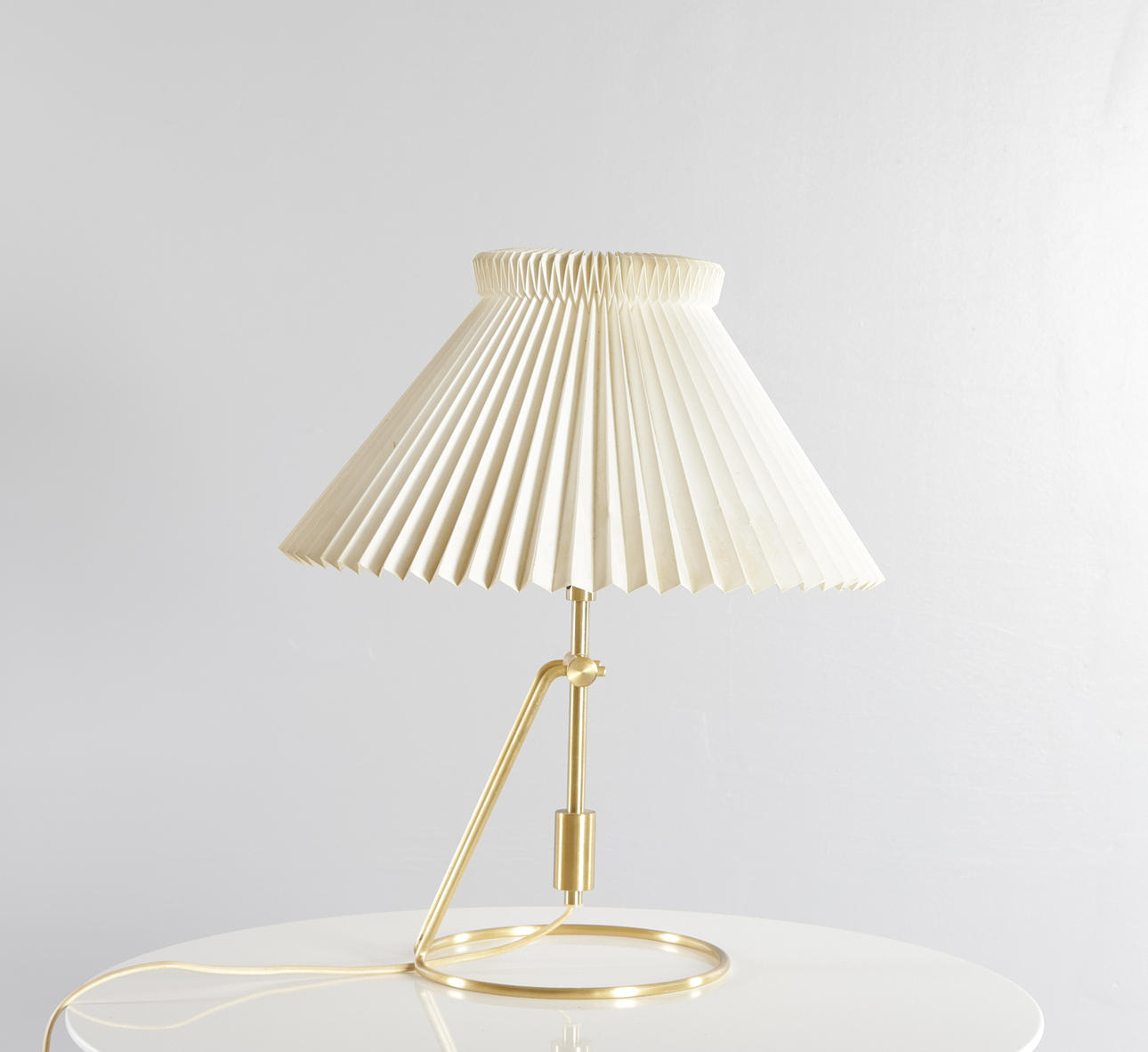CHRISTIAN HVIDT. Table/wall lamp with tilting frame made of brass and screen of pleated acrylic. Made and marked at Le Klint, model '305'.