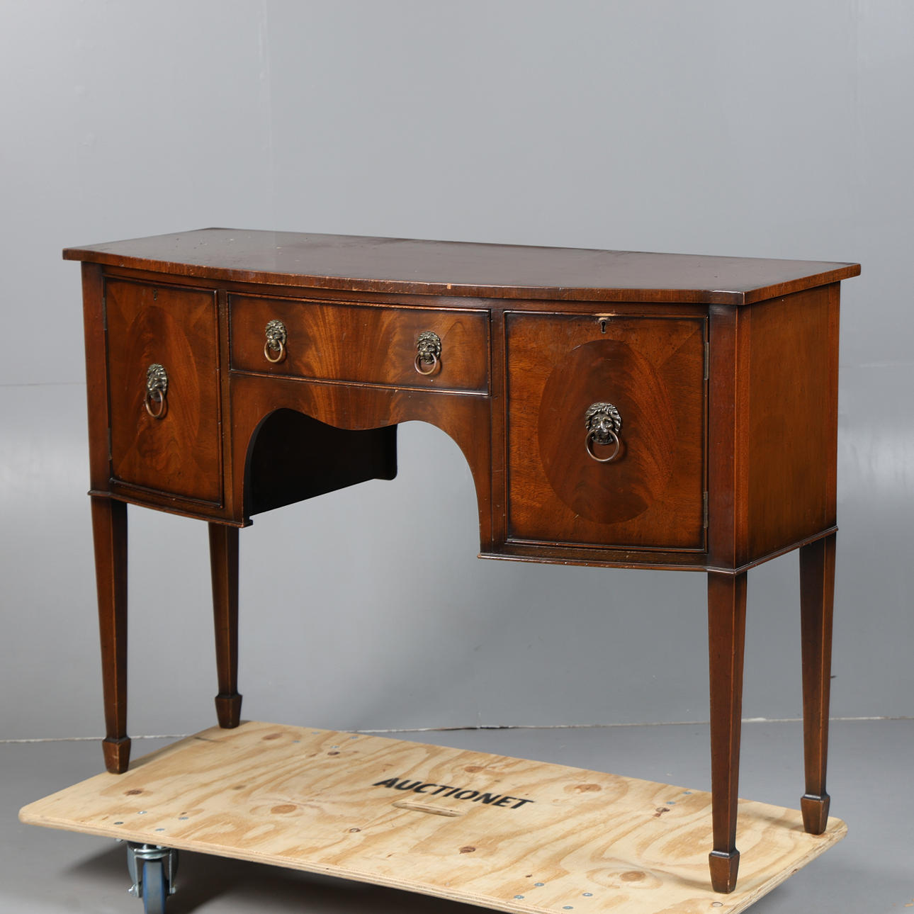 A REGENCY STYLE MAHOGANY BOW FRONT SIDEBOARD.