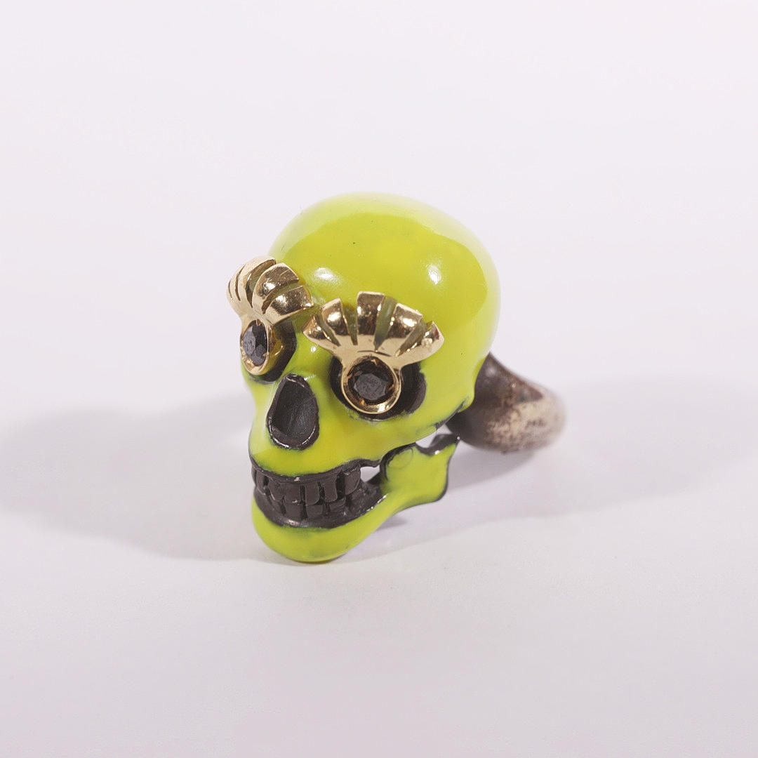 ALEXANDER MCQUEEN. SKULL RING. SILVER AND YELLOW GOLD.