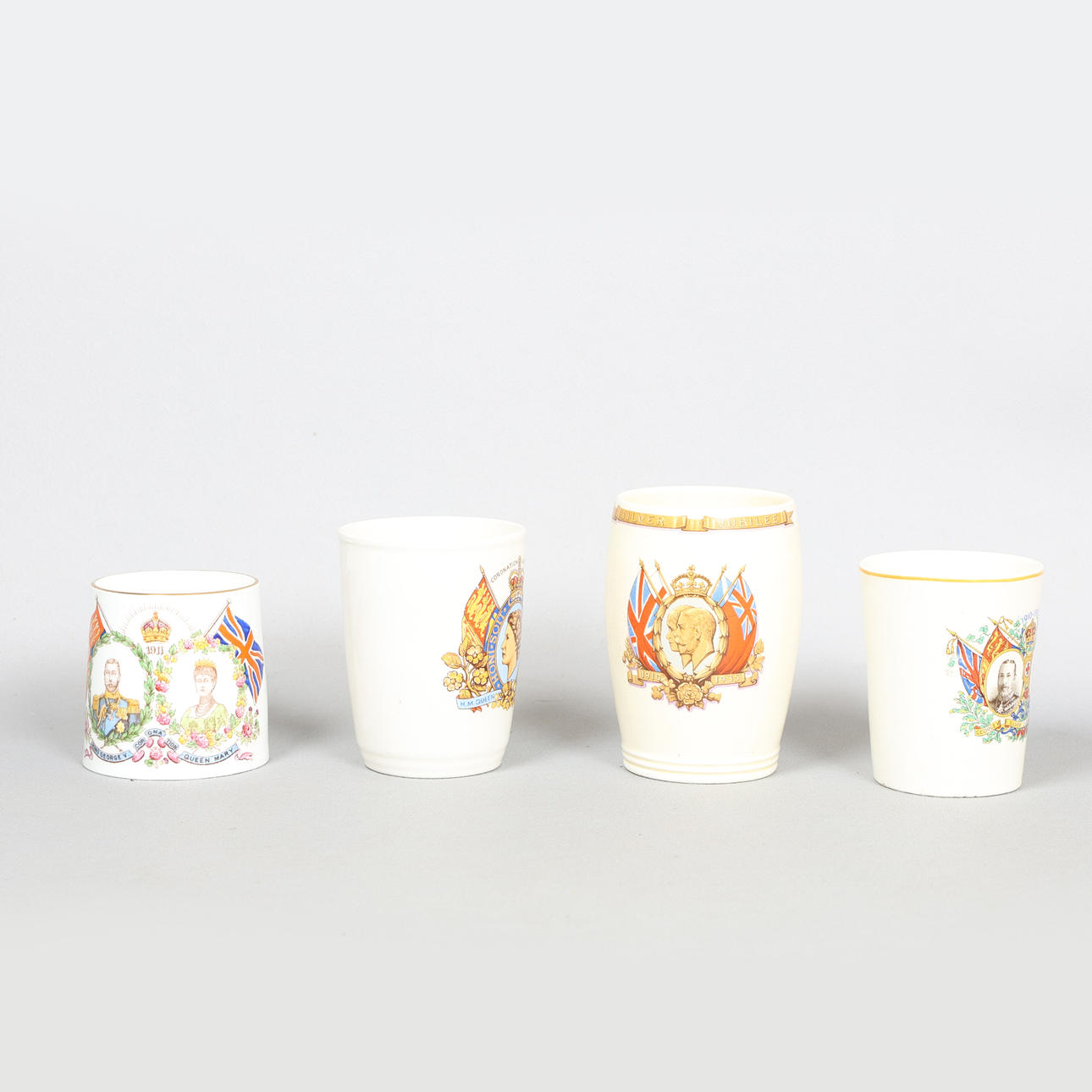 A GROUP OF FOUR ROYAL COMMEMORATIVE MUGS AND A BEAKER (4).