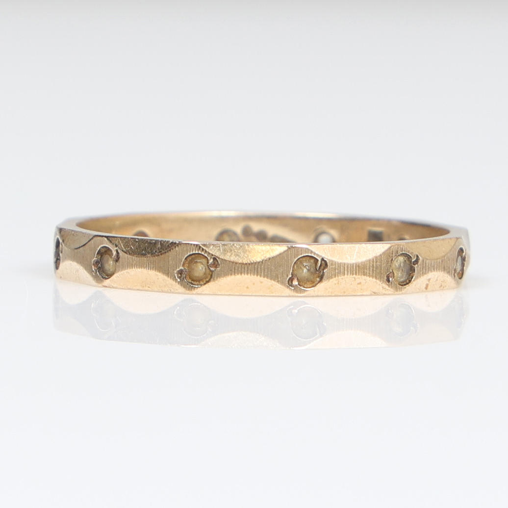 EN EVIGHEDSRING I 9 KARAT GULD OG KLAR PASTA.