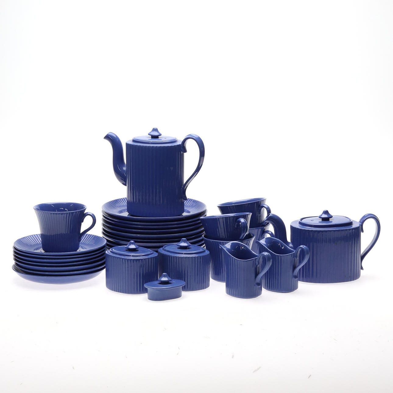 TABLEWARE PARTS. 30 PIECES, BLUE-GLAZED FLUTED STONEWARE.