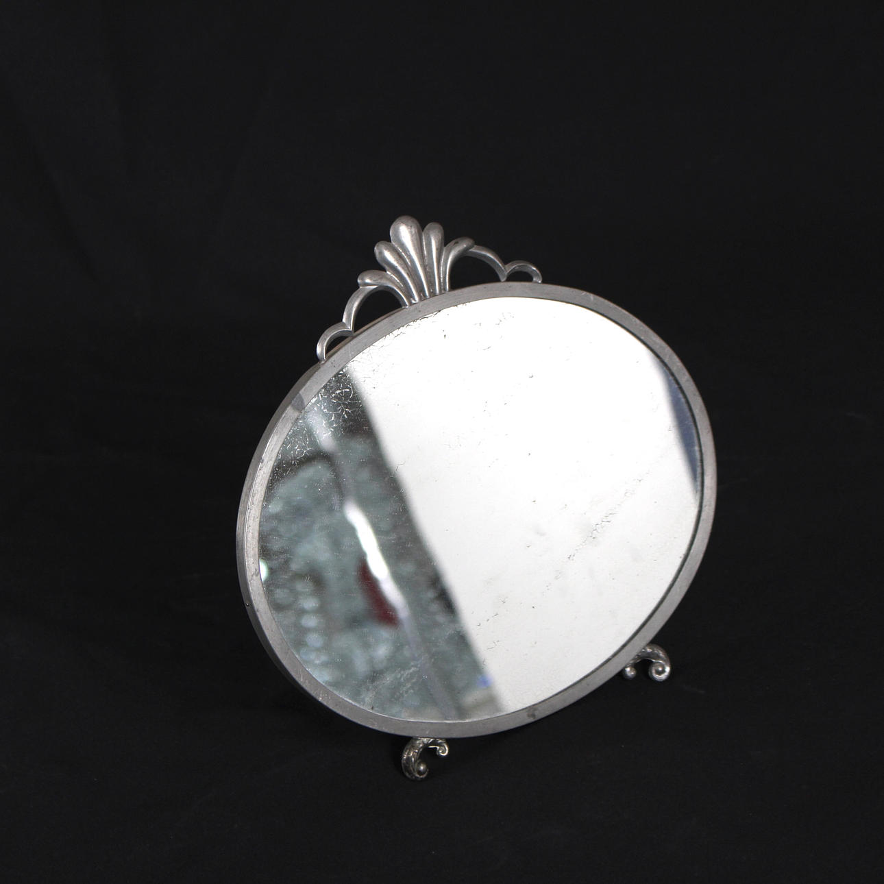 A 1930s art deco pewter mirror.