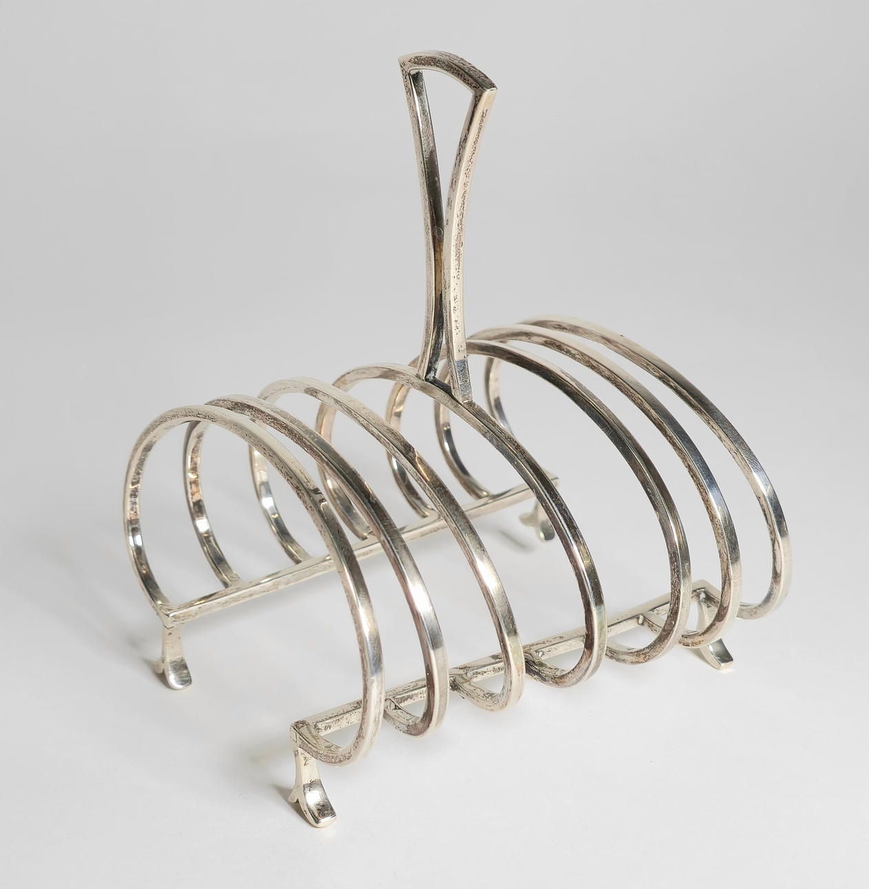 SILVER TOAST HOLDER.