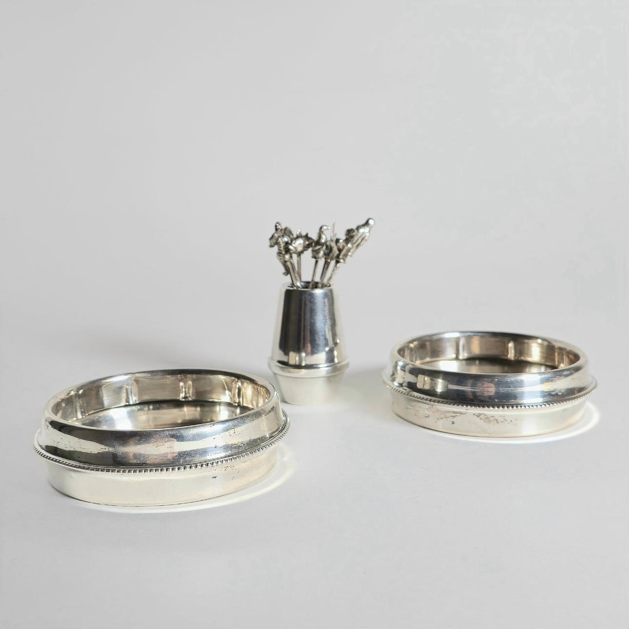 CHOPSTICKS, SILVER TOOTHPICK HOLDER AND TWO SNACK HOLDERS.