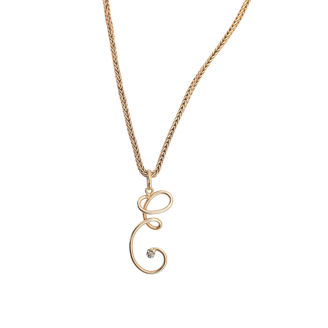 Pendant with initial in gold.