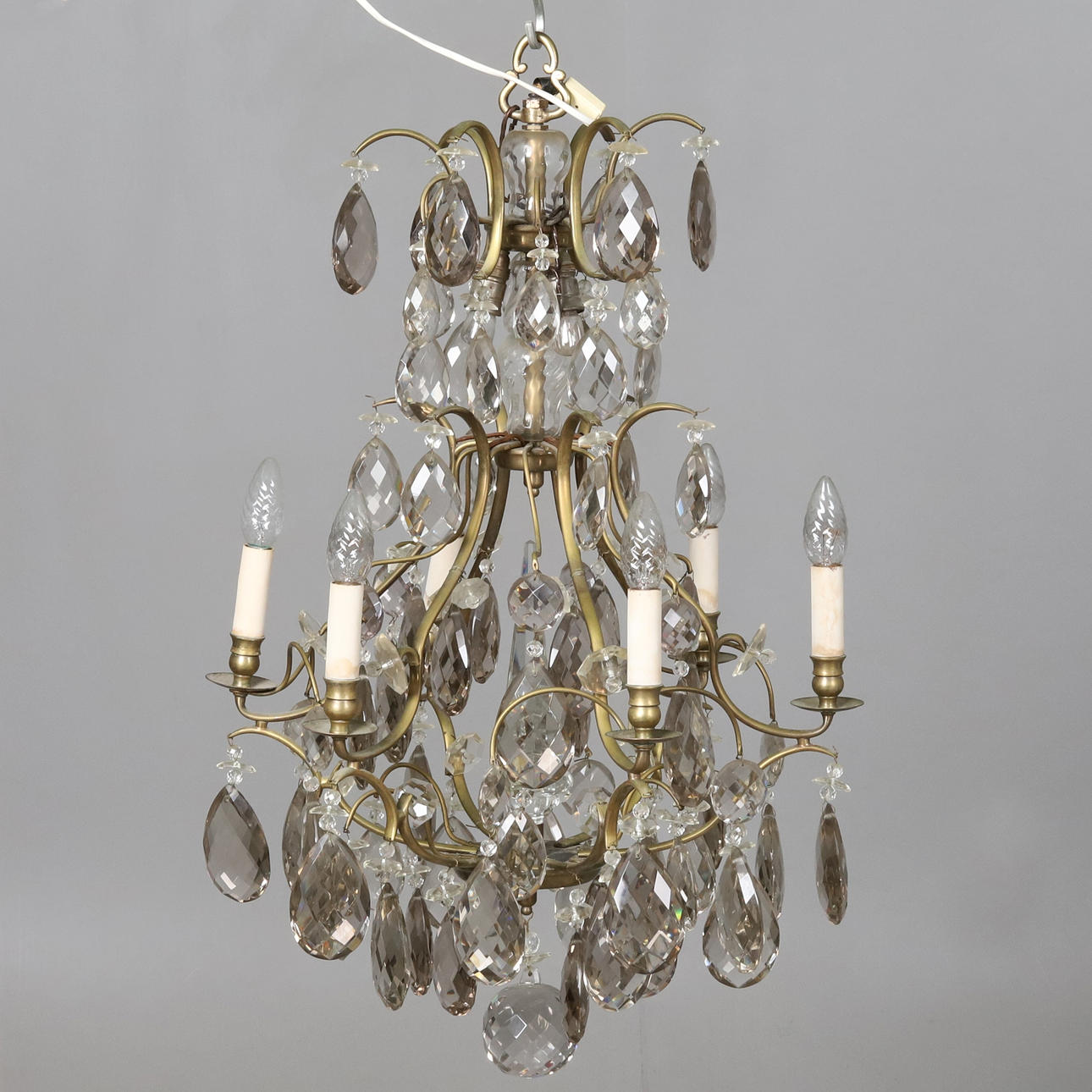 A rococo style chandelier, 6 arms, 9 points of light.