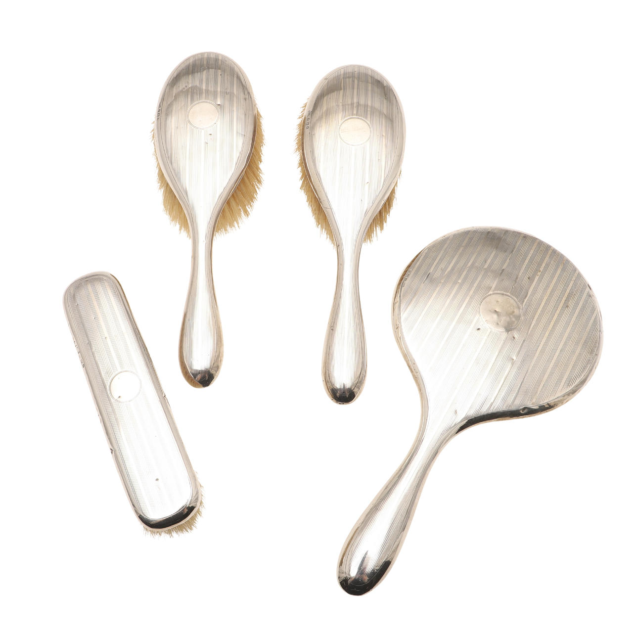 A FOUR PART SILVER BACKED DRESSING TABLE SET.