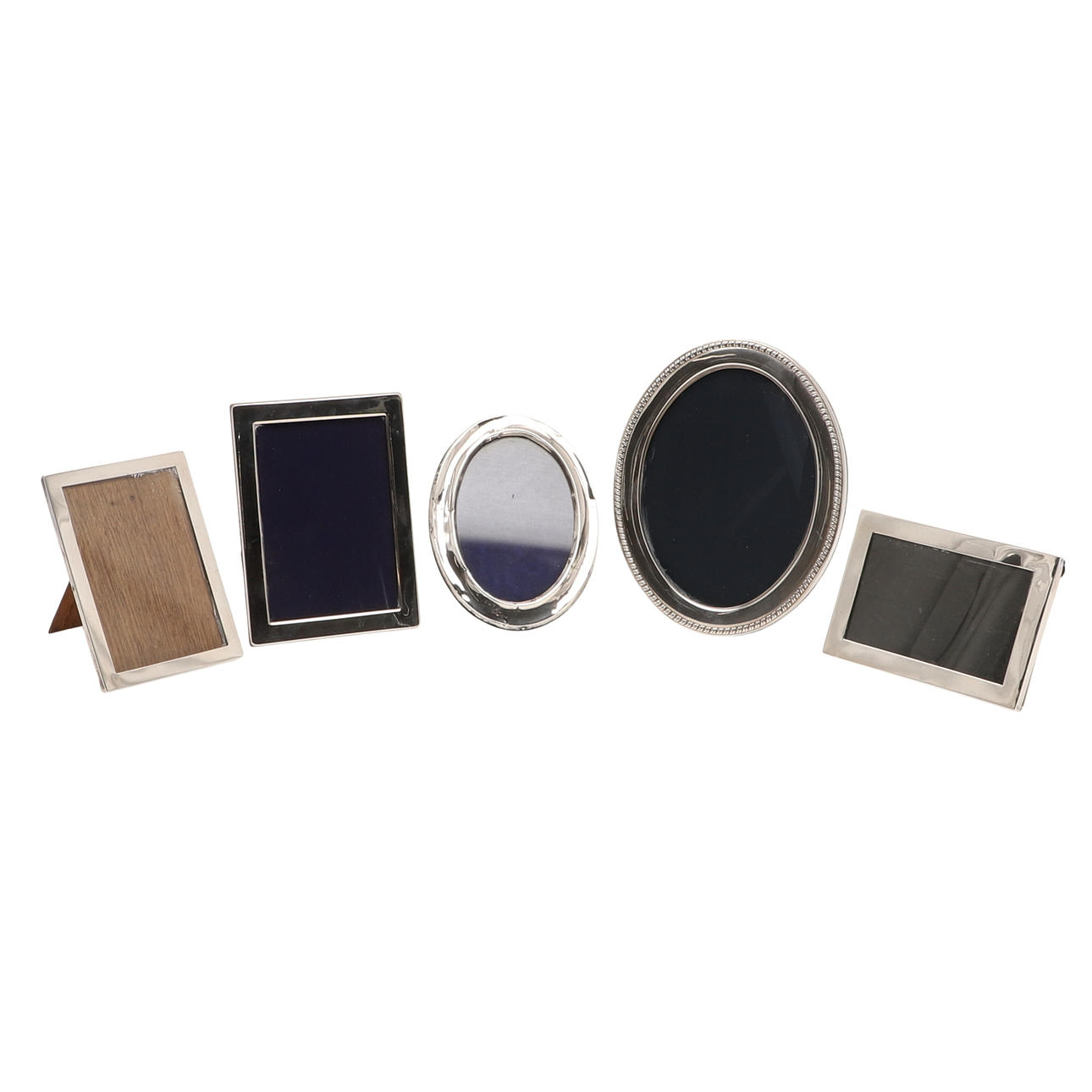 FIVE SILVER FACED PHOTO FRAMES.