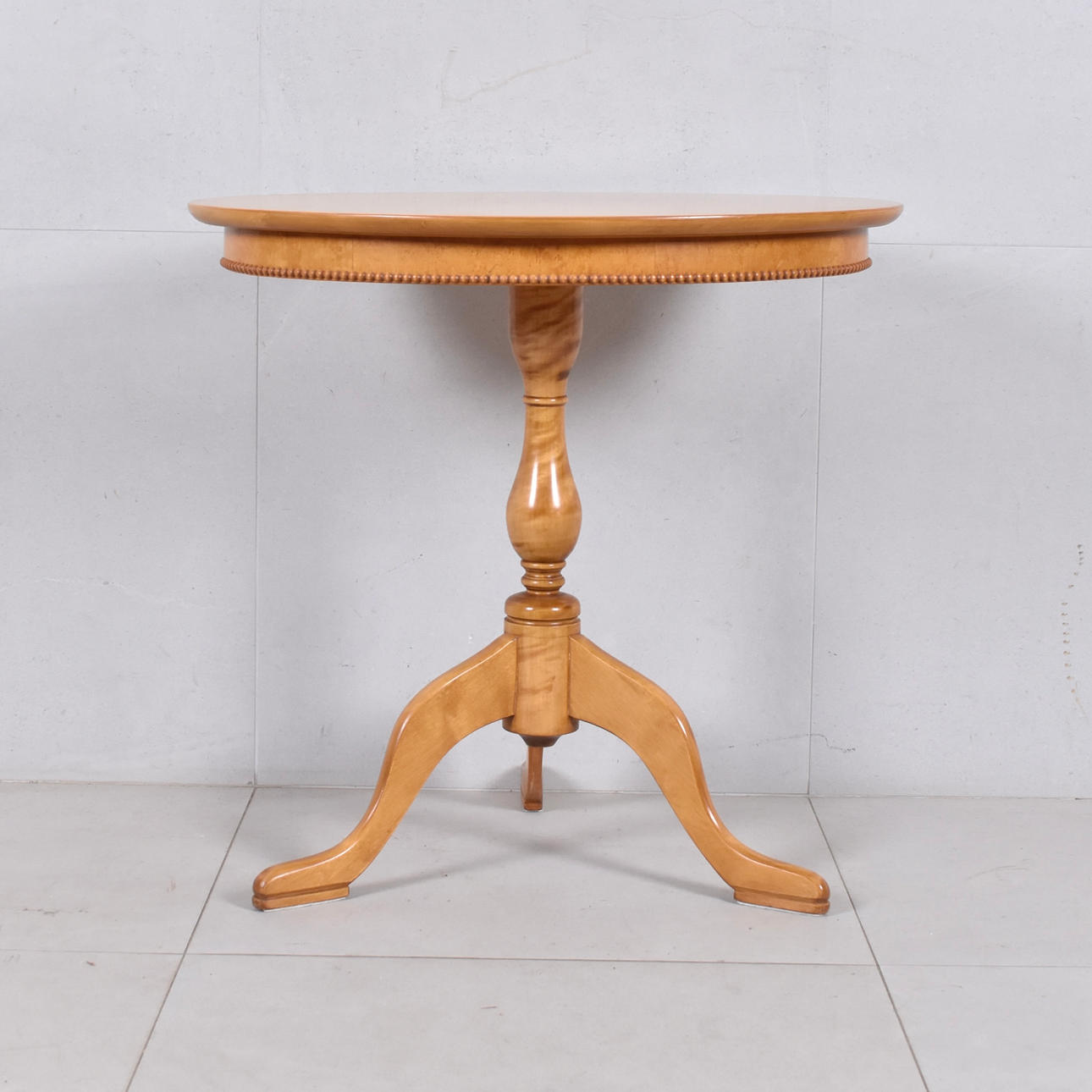 A 20th century birch pillar table.