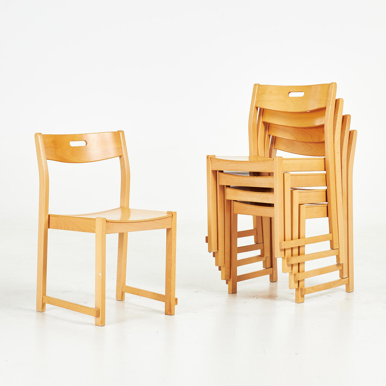 A set of 5 chairs, second half of the 20th century, veneered in beech, model after the “Orchestra chair”.