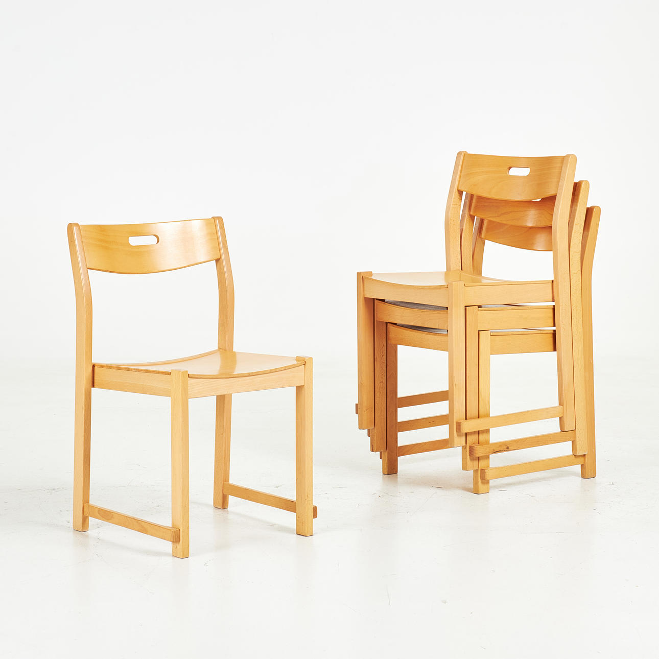 A set of four chairs, second half of the 20th century, veneered in beech, model after the “Orchestra chair”.