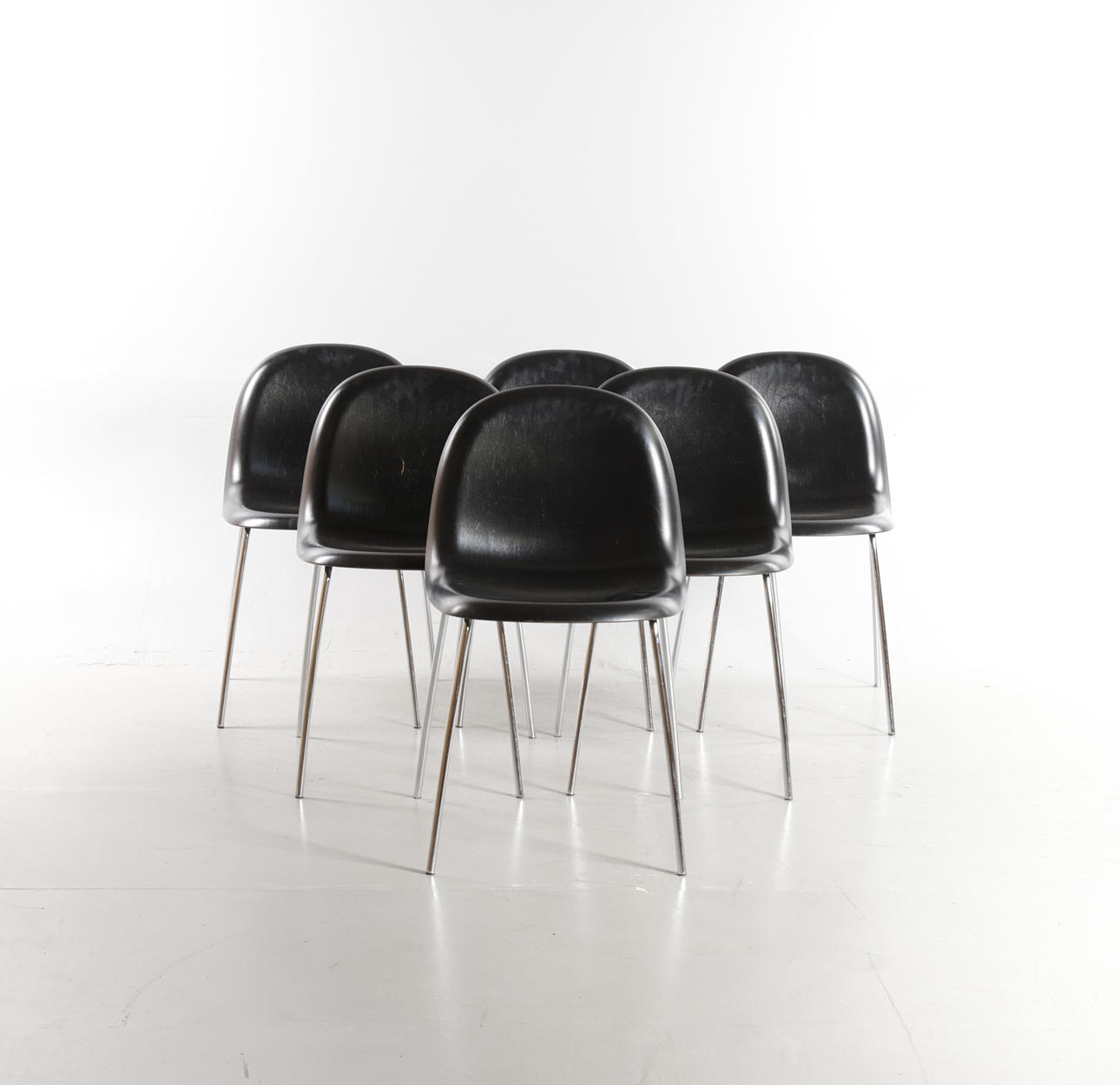 KOMPLOT DESIGN. Set of six dining chairs with shells of black lasur painted beech, frame of chrome-plated metal. Manufactured at Gubi, model “3D Dining Chair”. (6th).