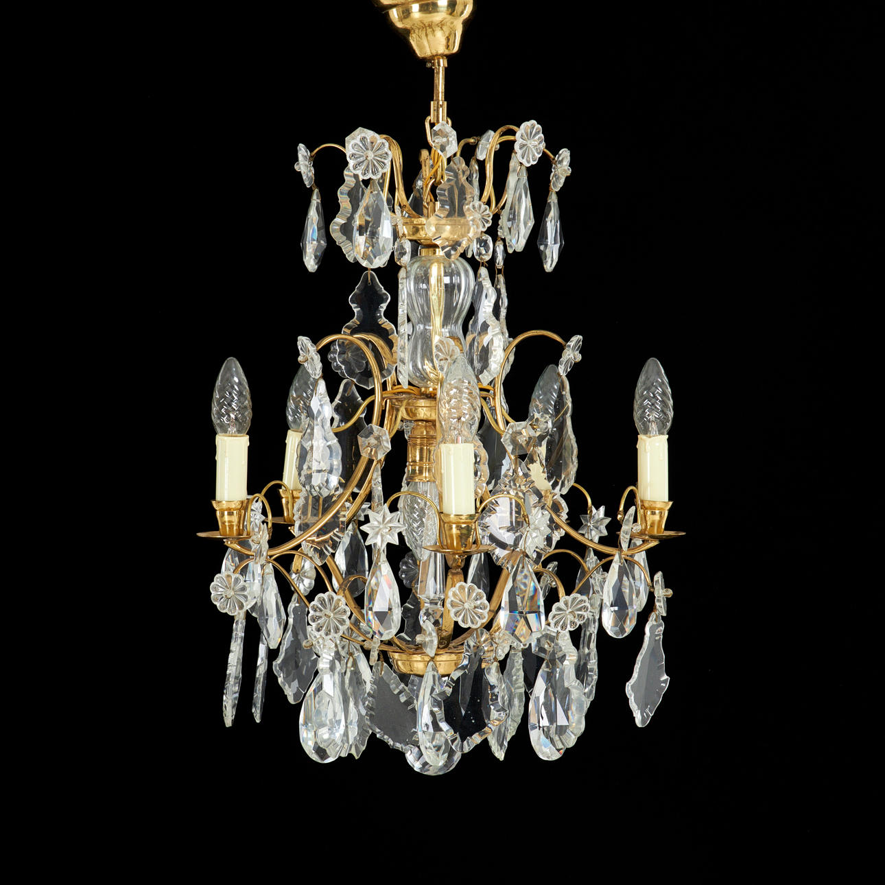 A 20th century Rococo chandelier, brass frame, different cut prisms.