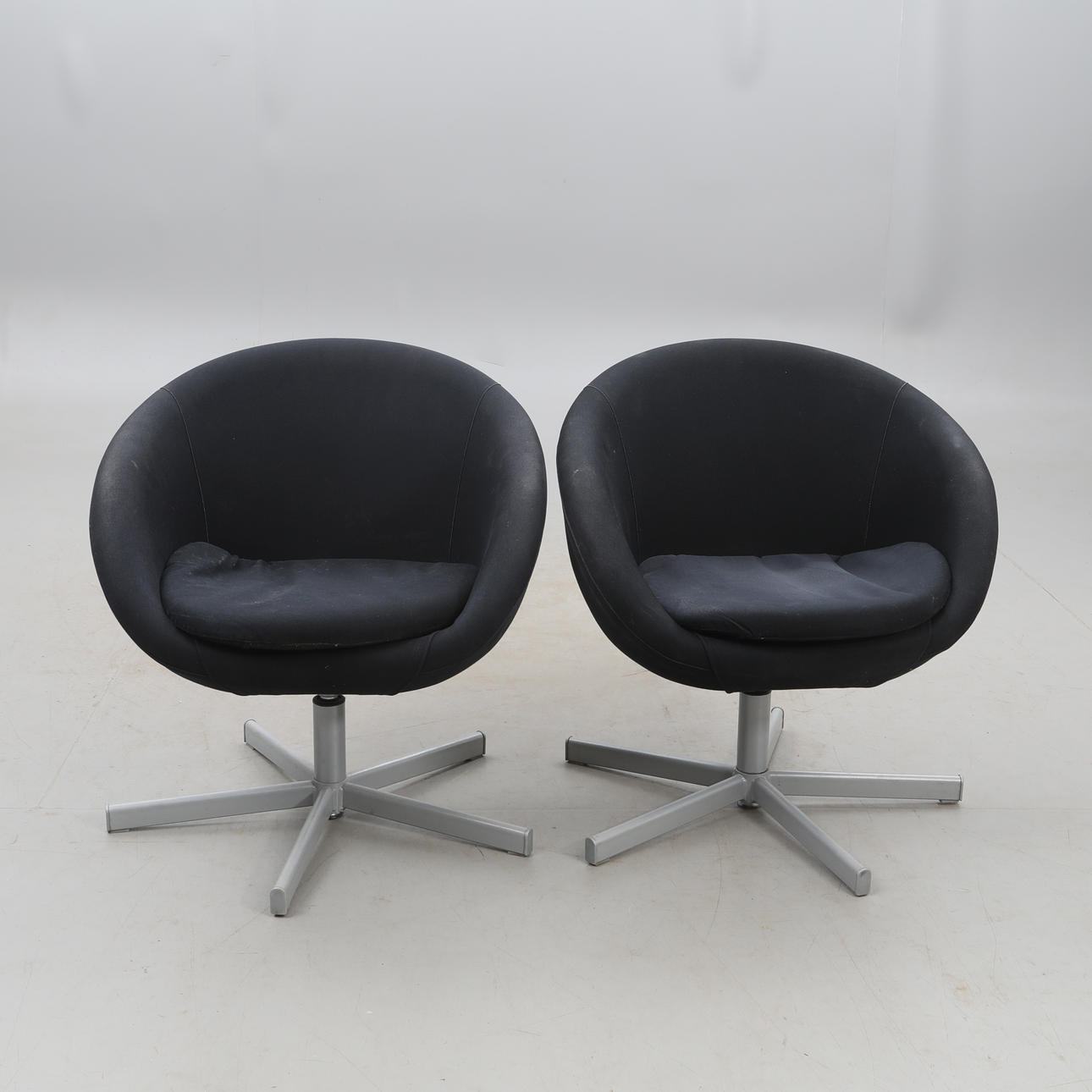 A pair of spinning armchairs.