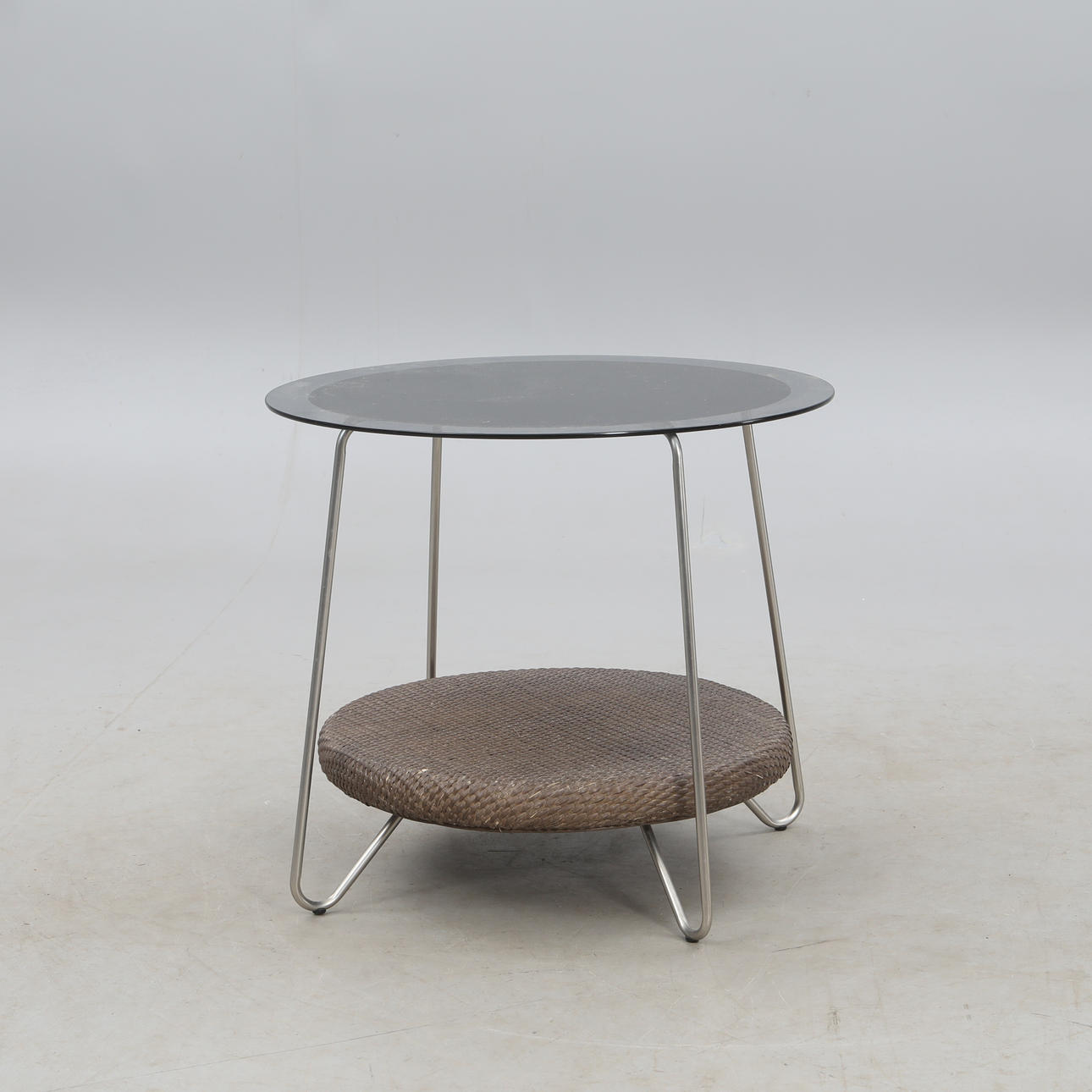 GLASS TABLE WITH BRAIDED SHELF.