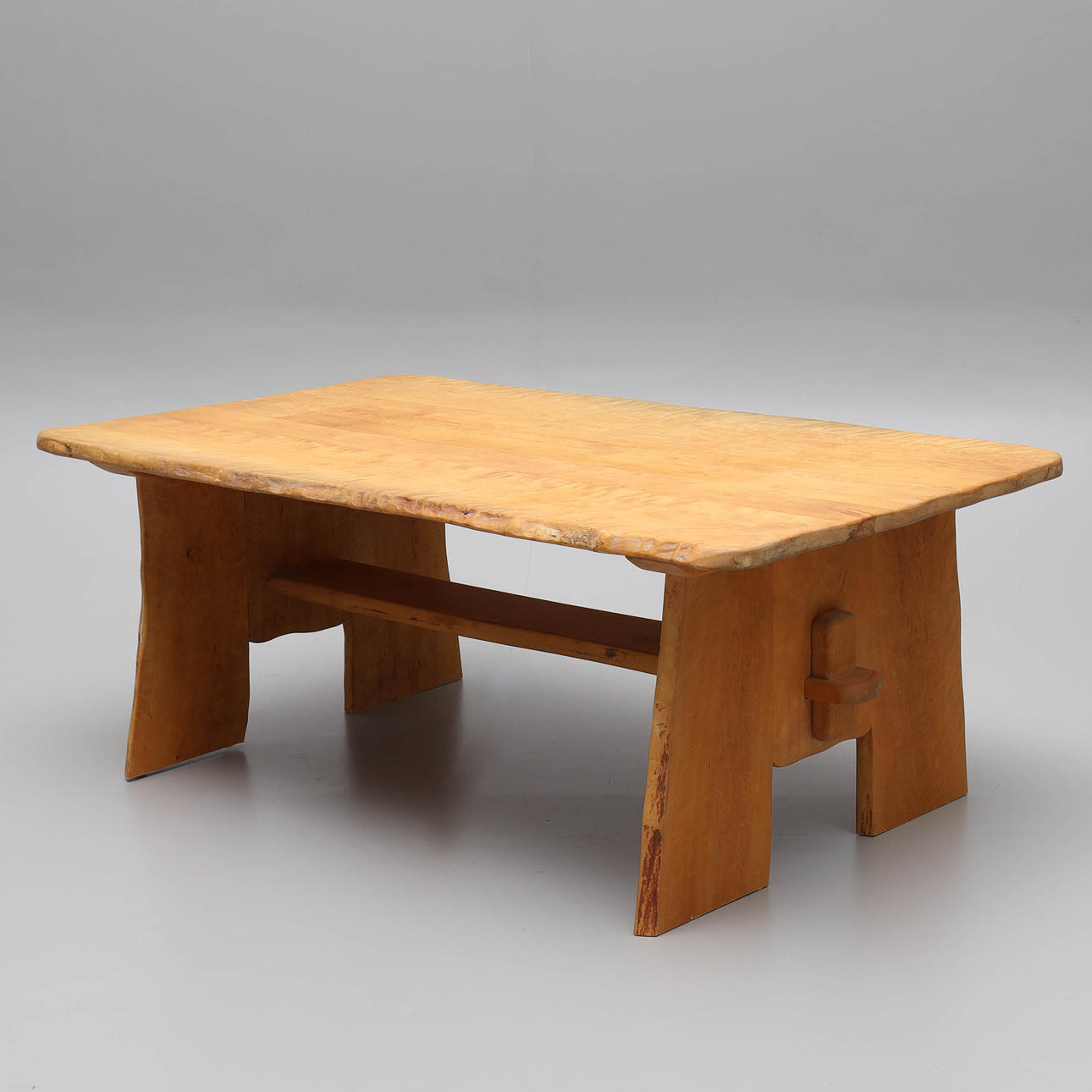 A 20th century birch “trestle table” coffee table.