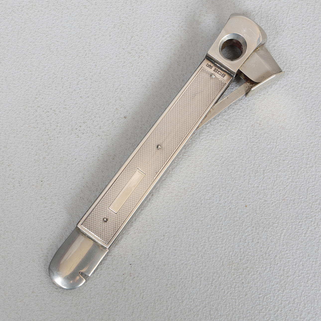 AN ELIZABETH II SILVER CIGAR CUTTER.